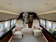 Luxurious interior of a private jet with comfortable seating.