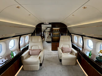 Luxurious interior of a private jet with comfortable seating.