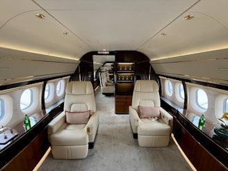 Luxurious interior of a private jet with comfortable seating.