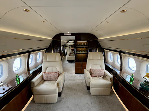 Luxurious interior of a private jet with comfortable seating.