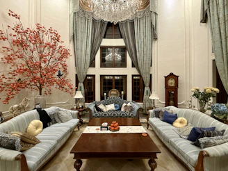 Elegant living room with ornate chandelier and seating.