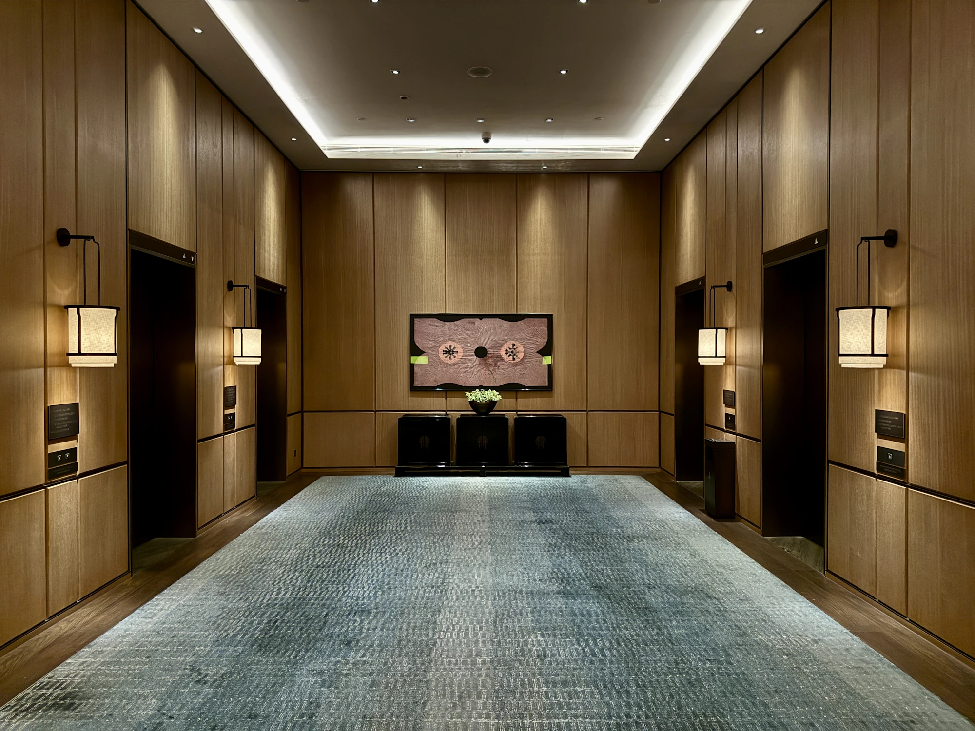 Hotel lift lobby with timber walls