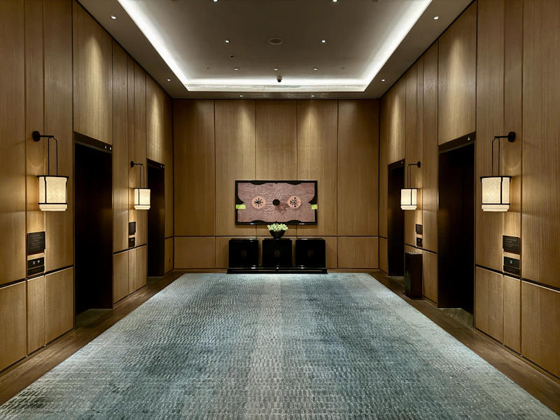 Modern hotel lobby with elevator doors and artwork