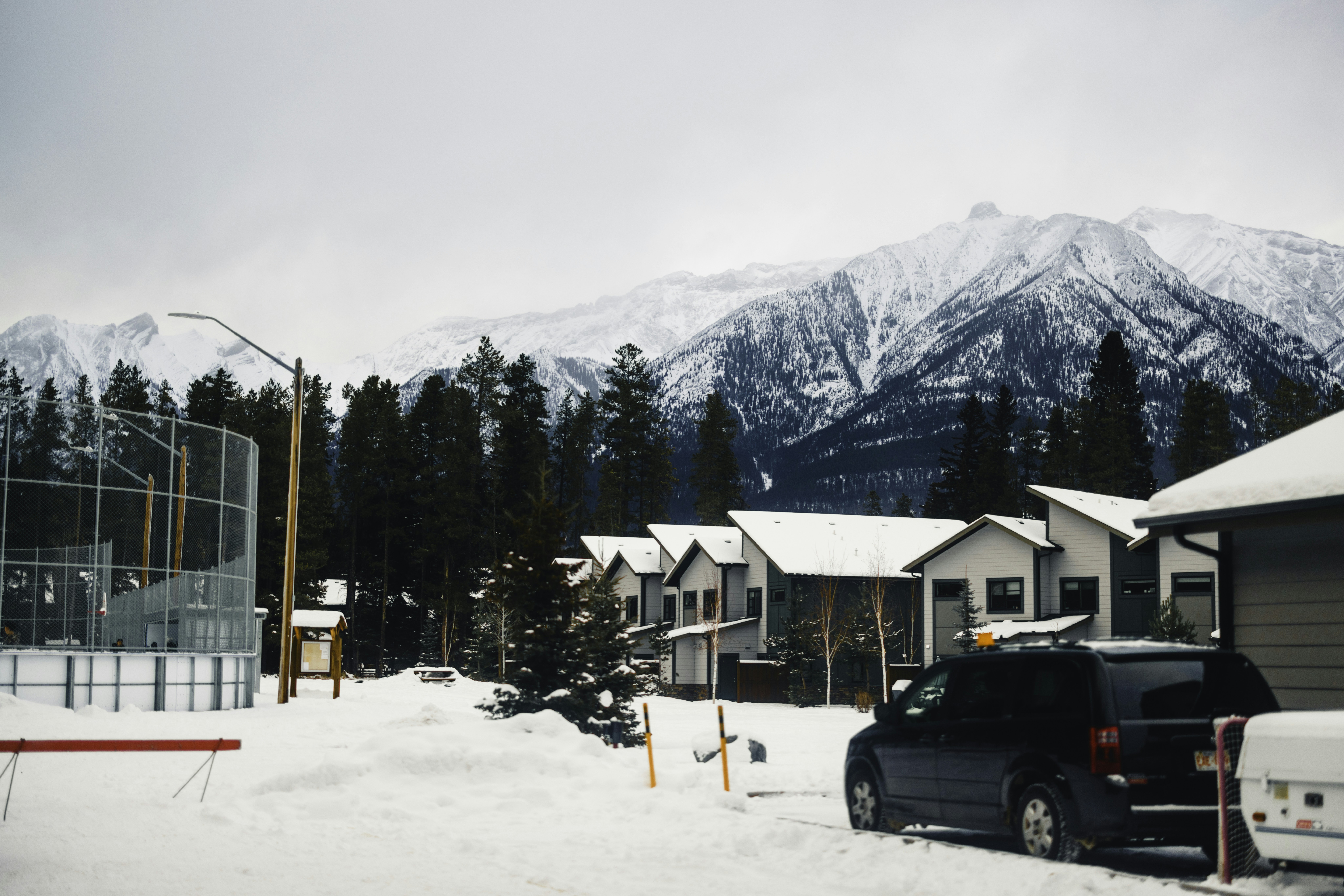 Snowy mountain village with evergreen trees and houses