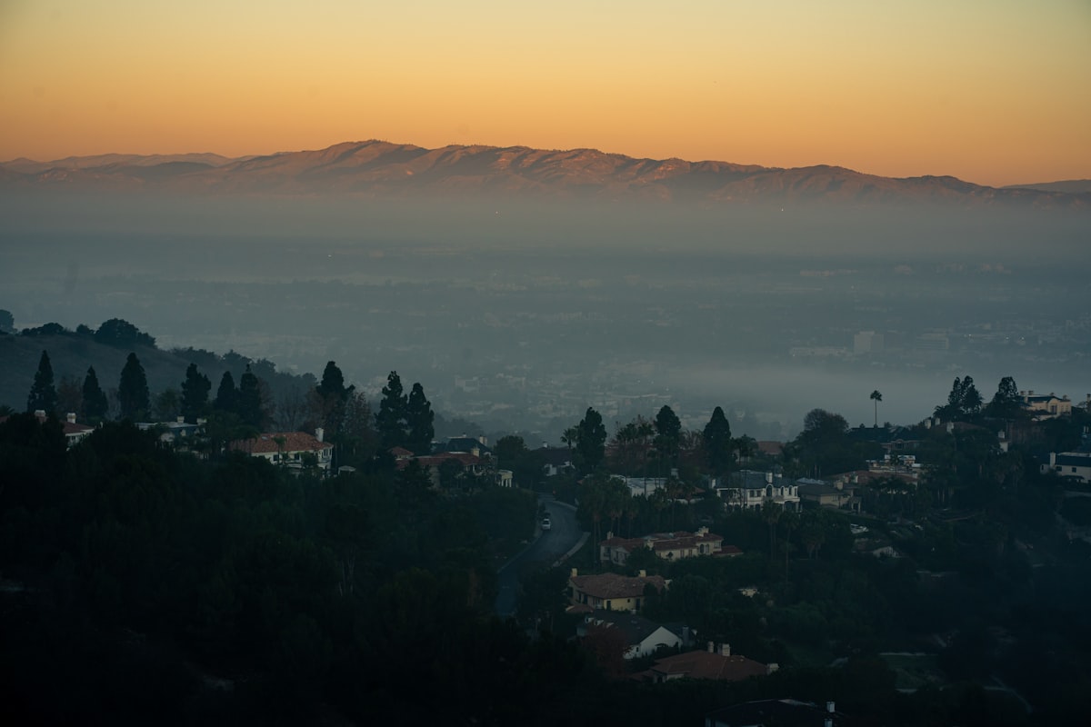 Hazy valley with distant mountains at sunrise