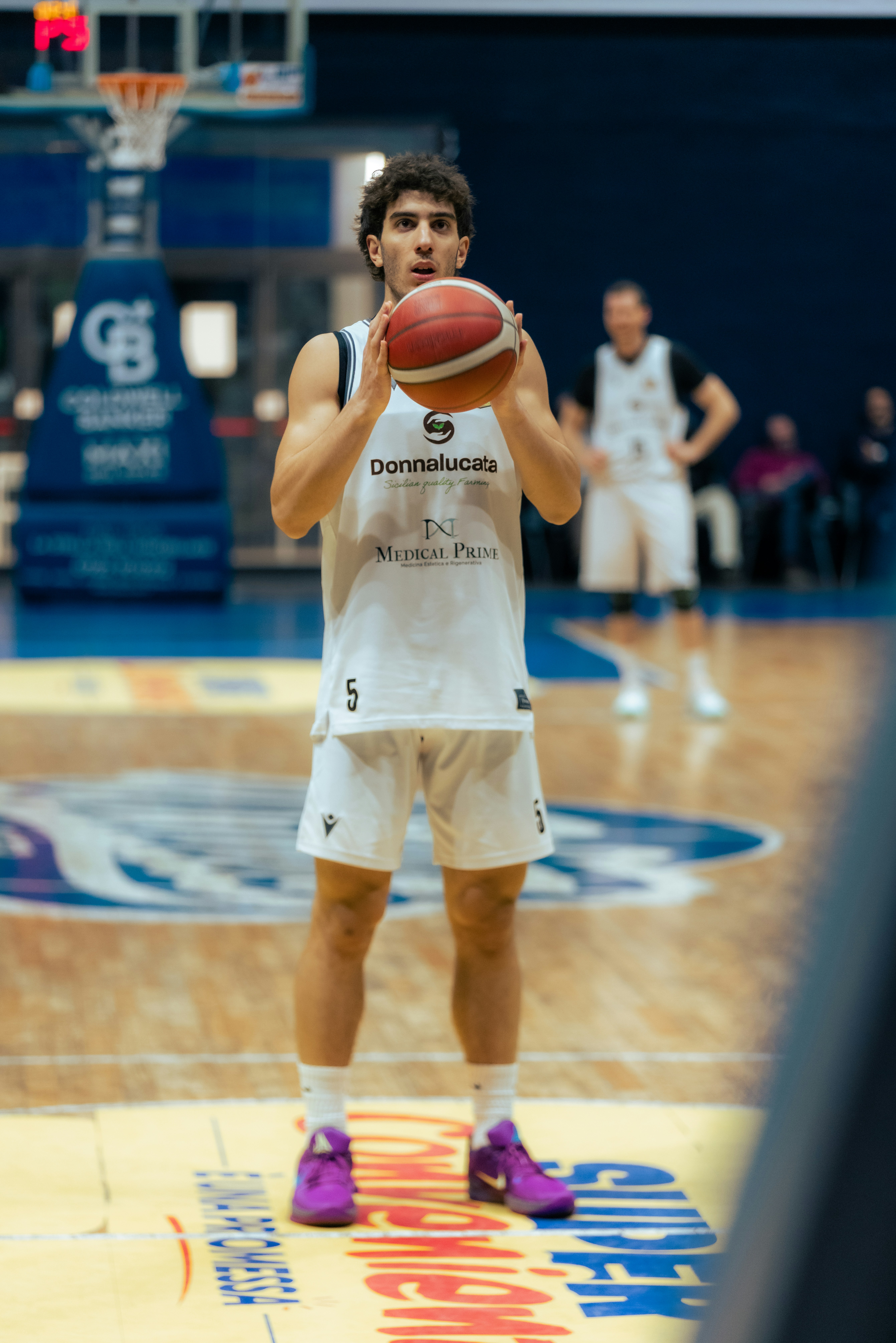 Basketball player holding ball on court