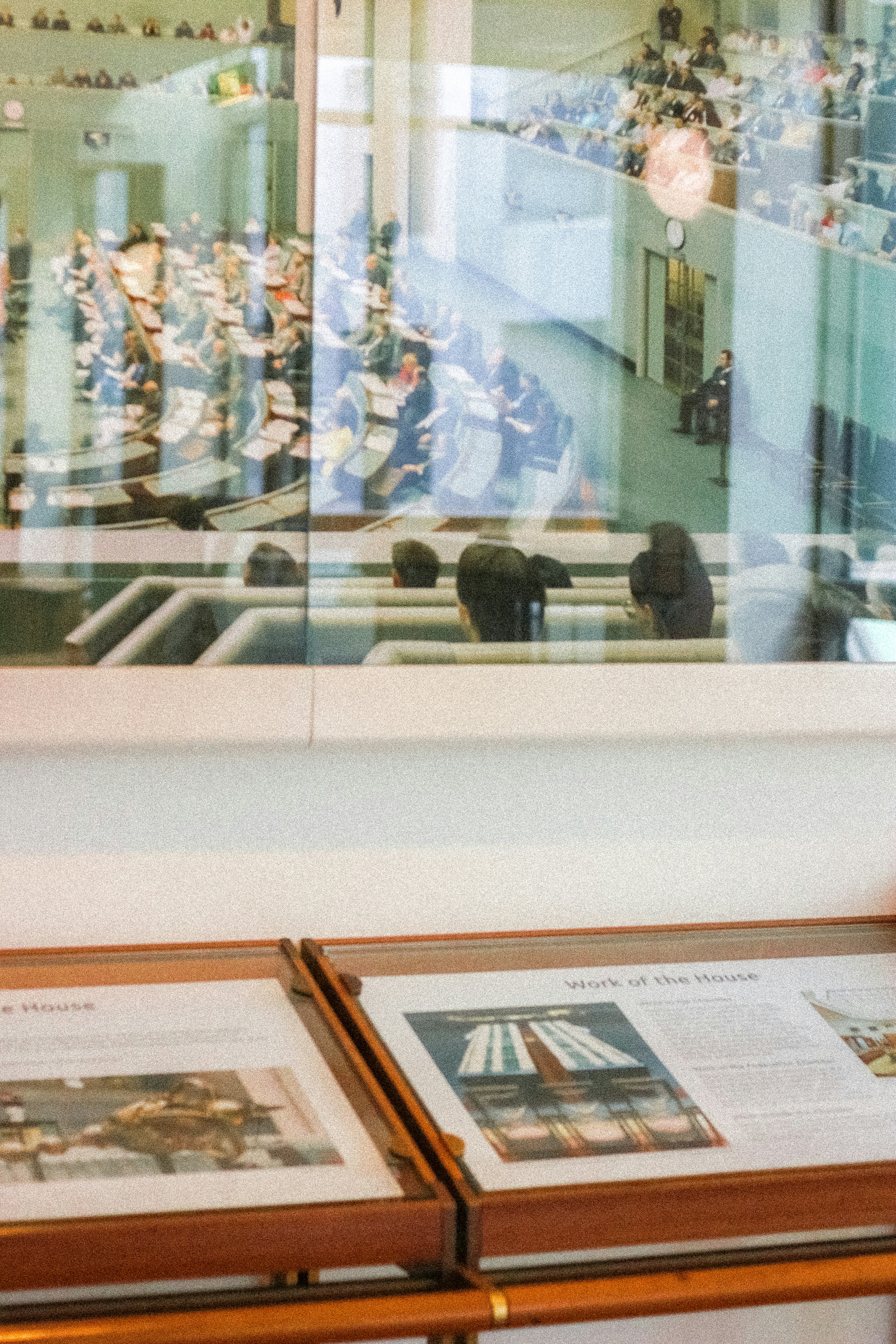 Interior of a government building with people seated