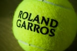 A close-up of a roland garros tennis ball.