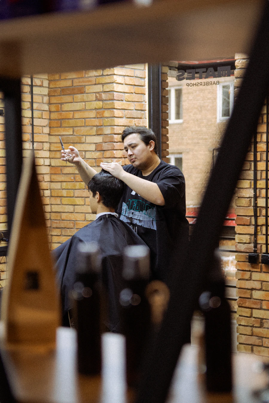 A barber concentrating on a haircut