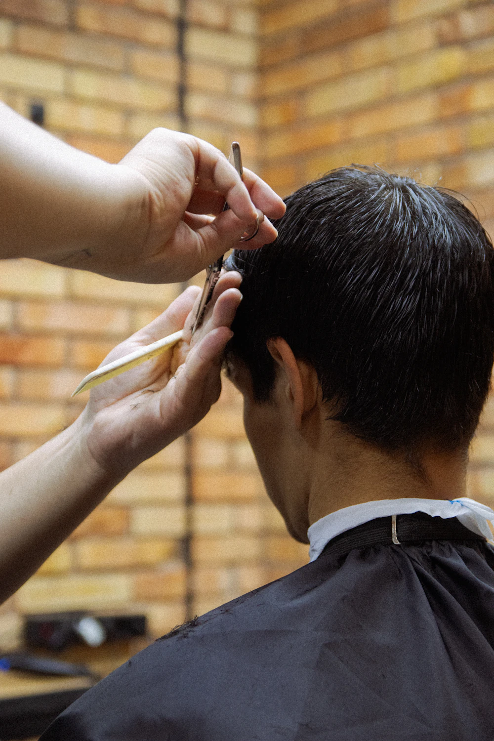 Barber completing scissor work at [BUSINESS_NAME]