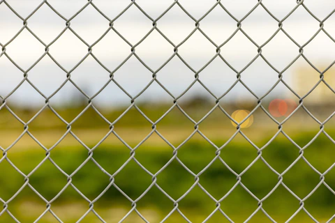 Close-up of a chain-link fence depicting disconnection from others