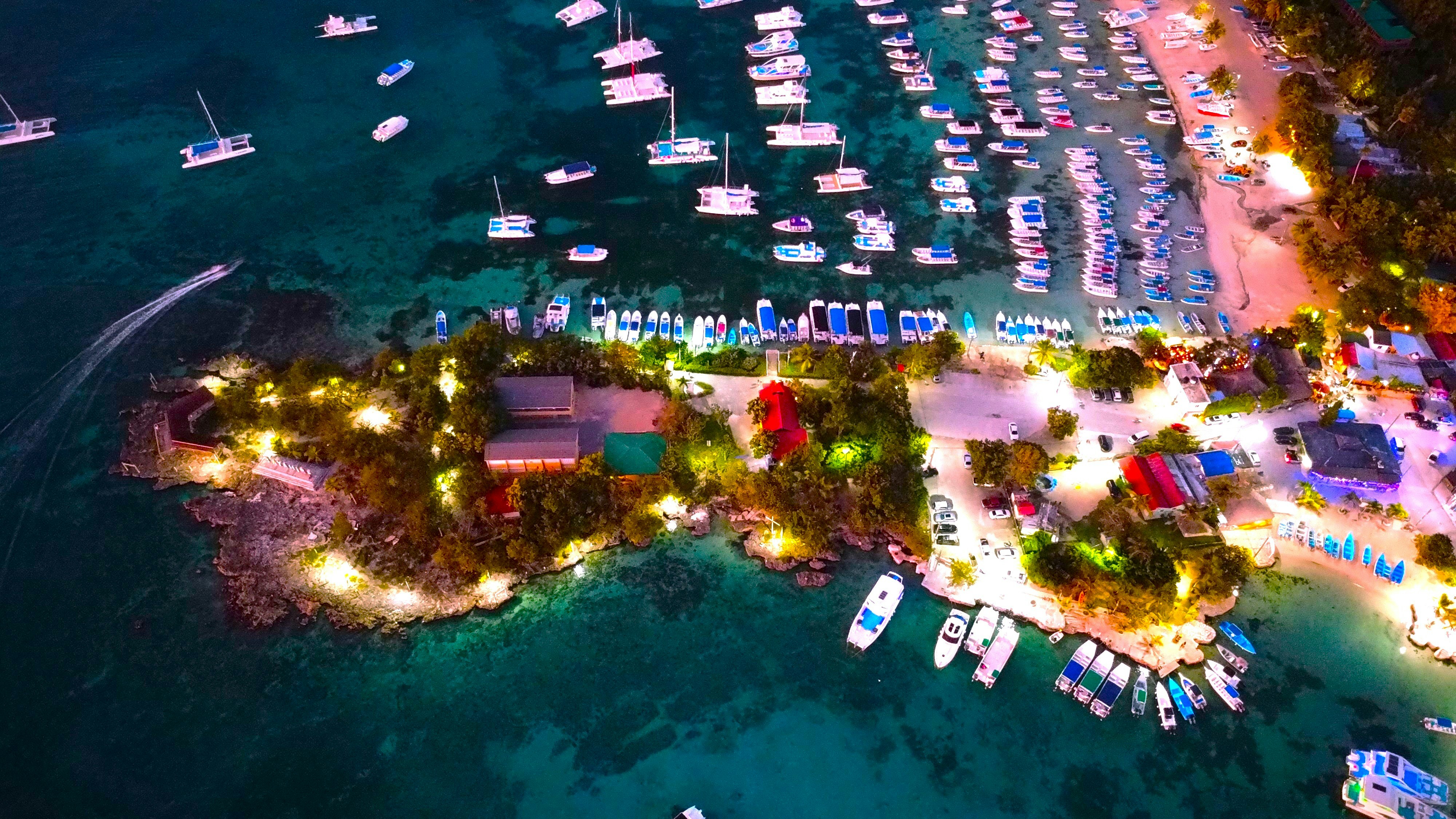 Aerial view of a harbor filled with boats at night.