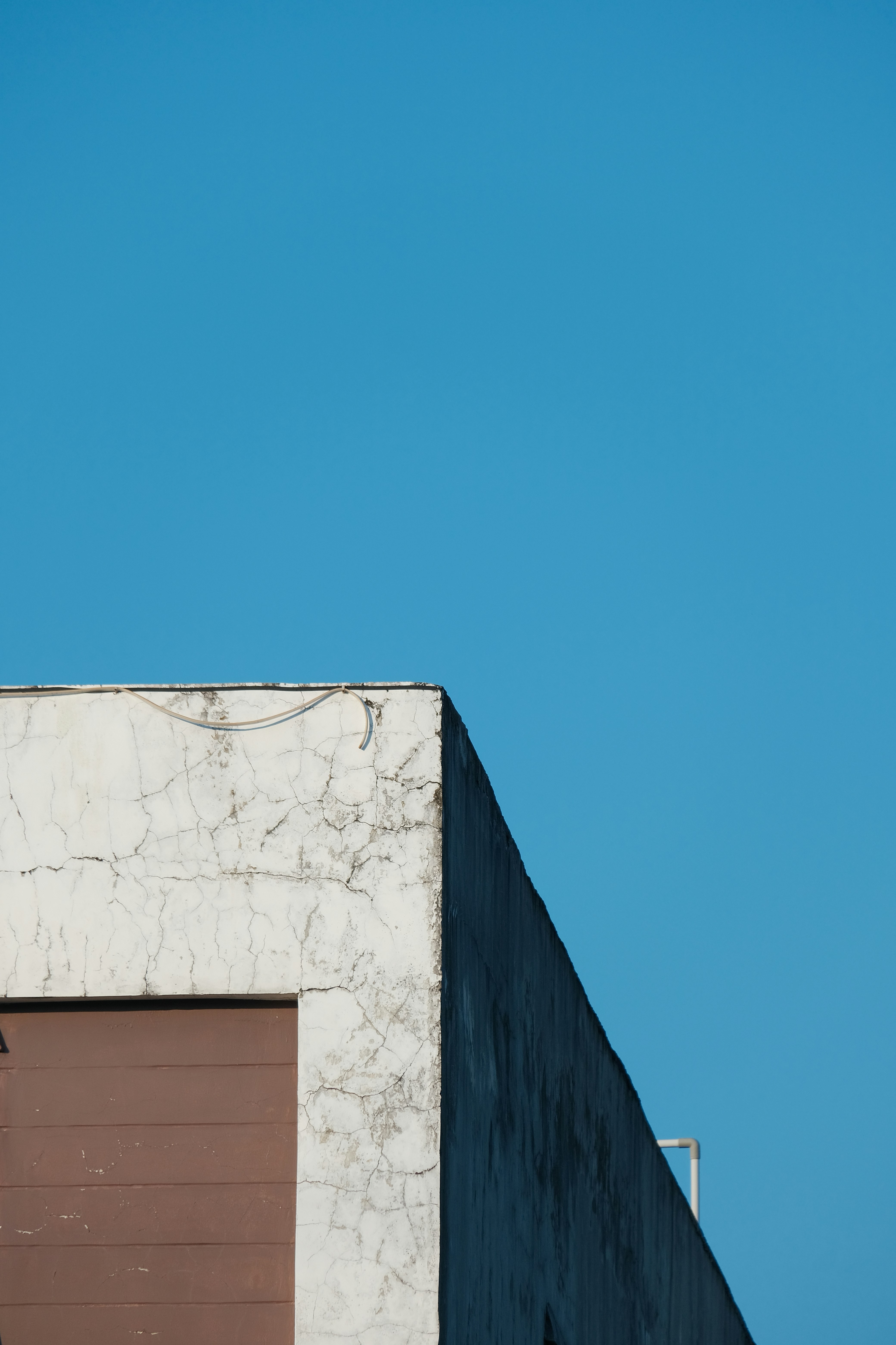 Corner of a building against a clear blue sky