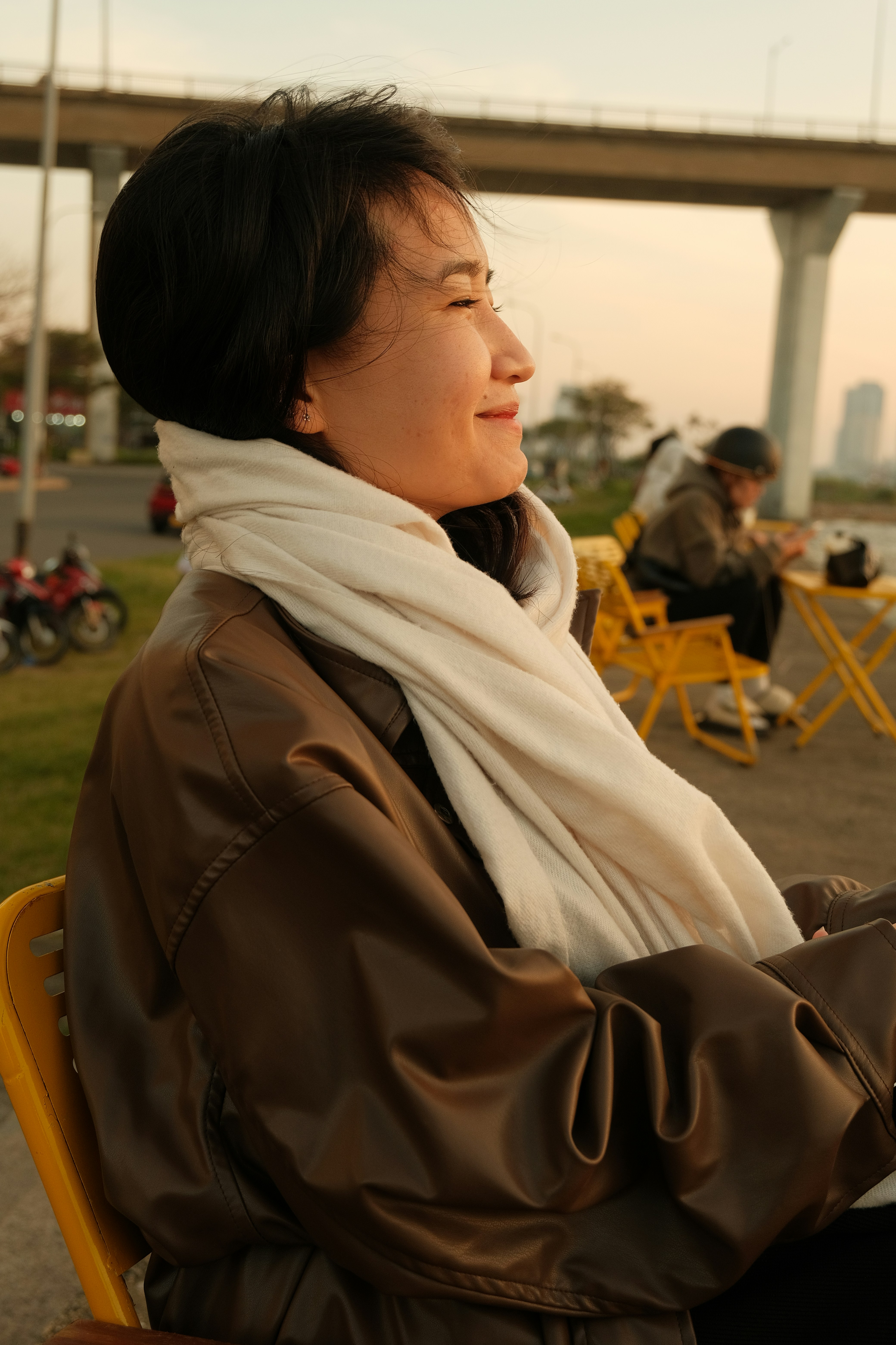Woman wearing a scarf and jacket outdoors