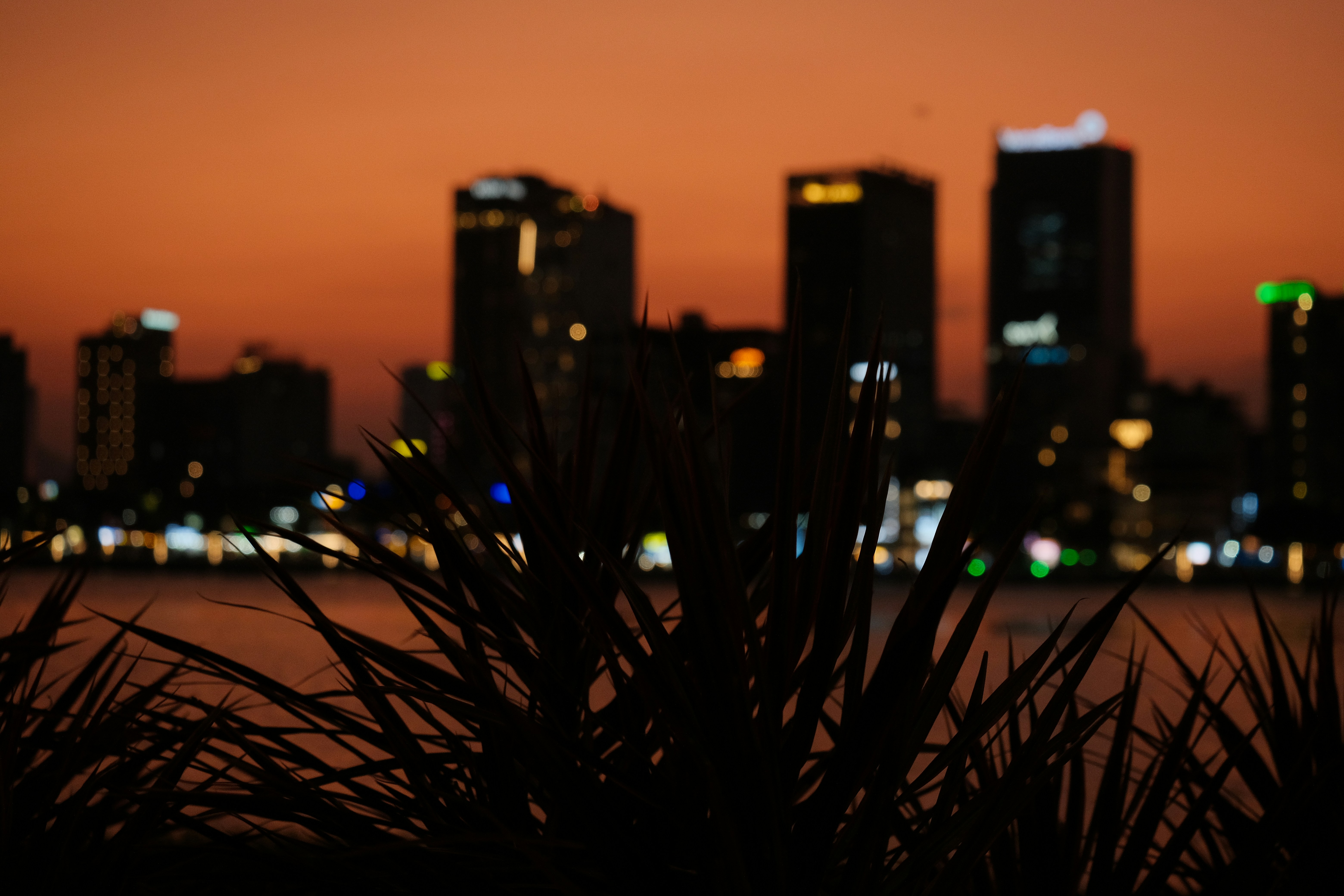City skyline at dusk with water in foreground