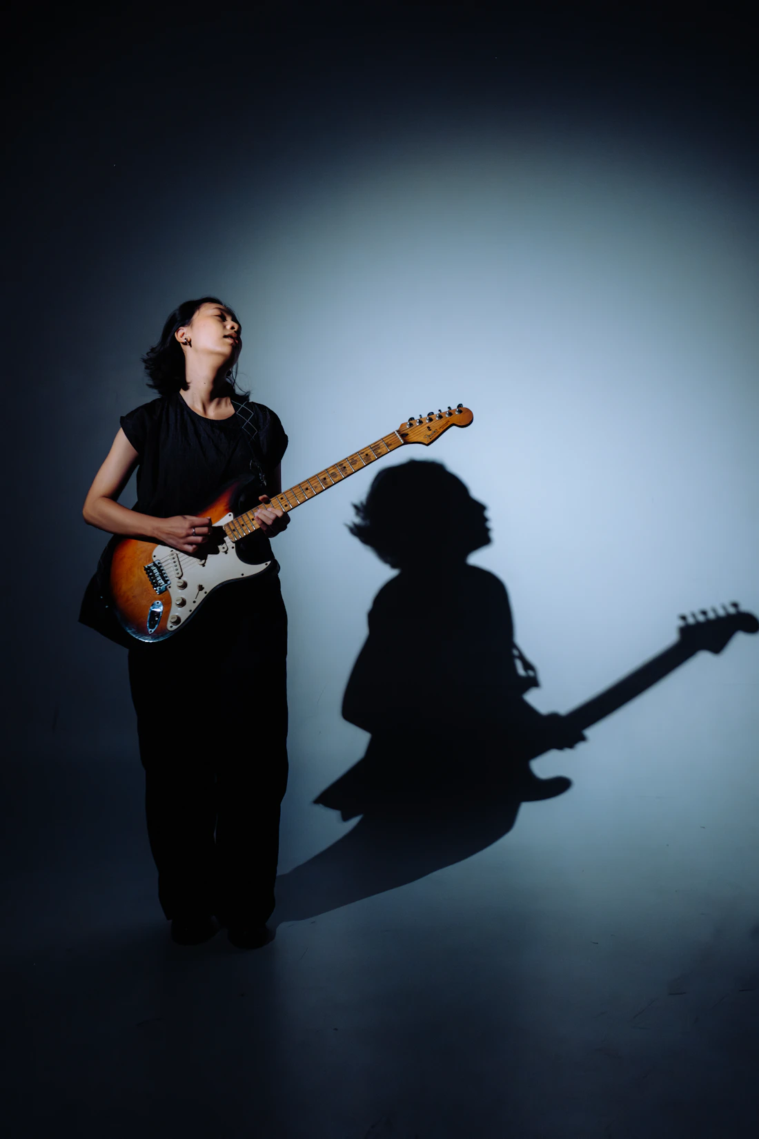 Female musician playing an electric guitar