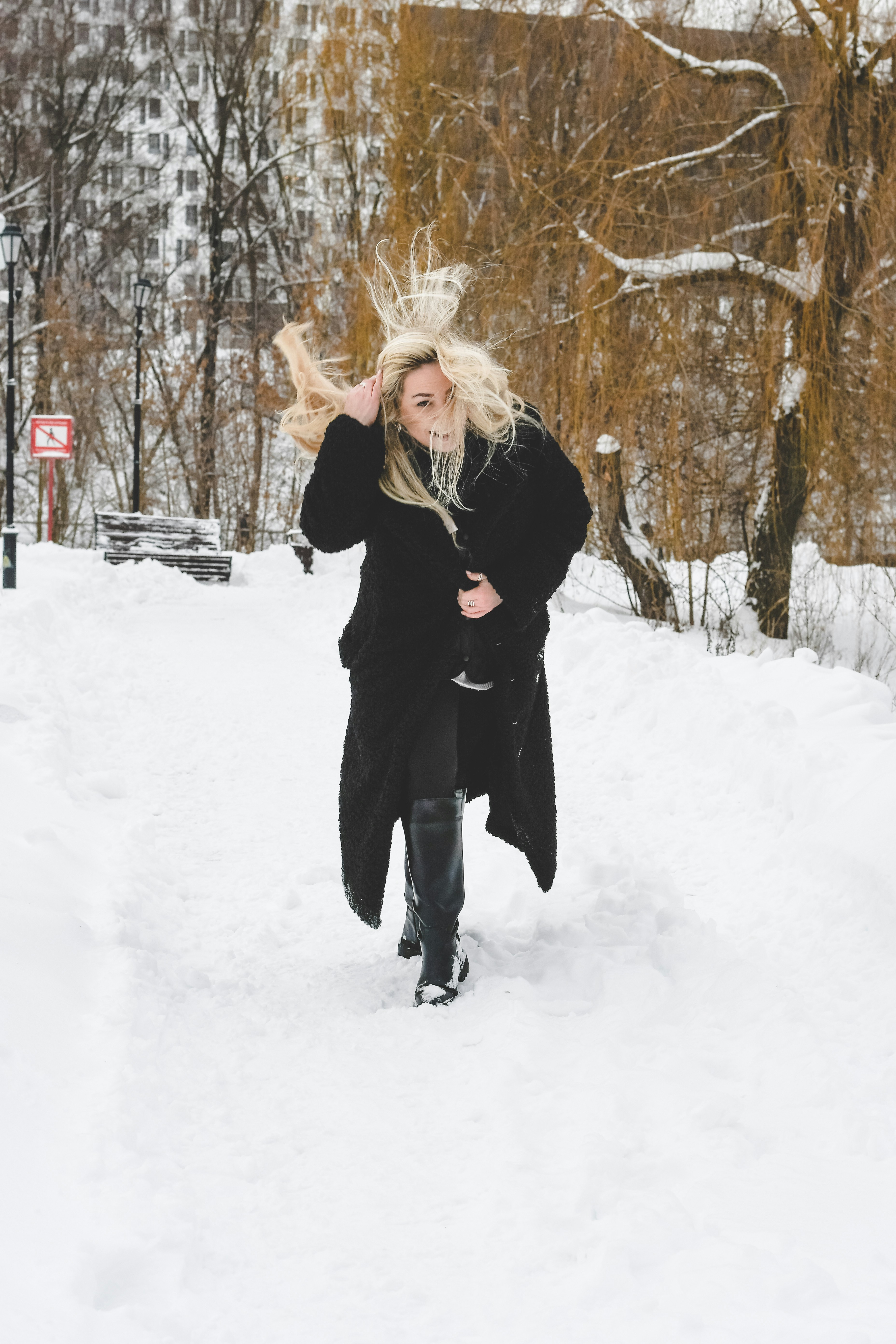 Woman with blonde hair running through snow