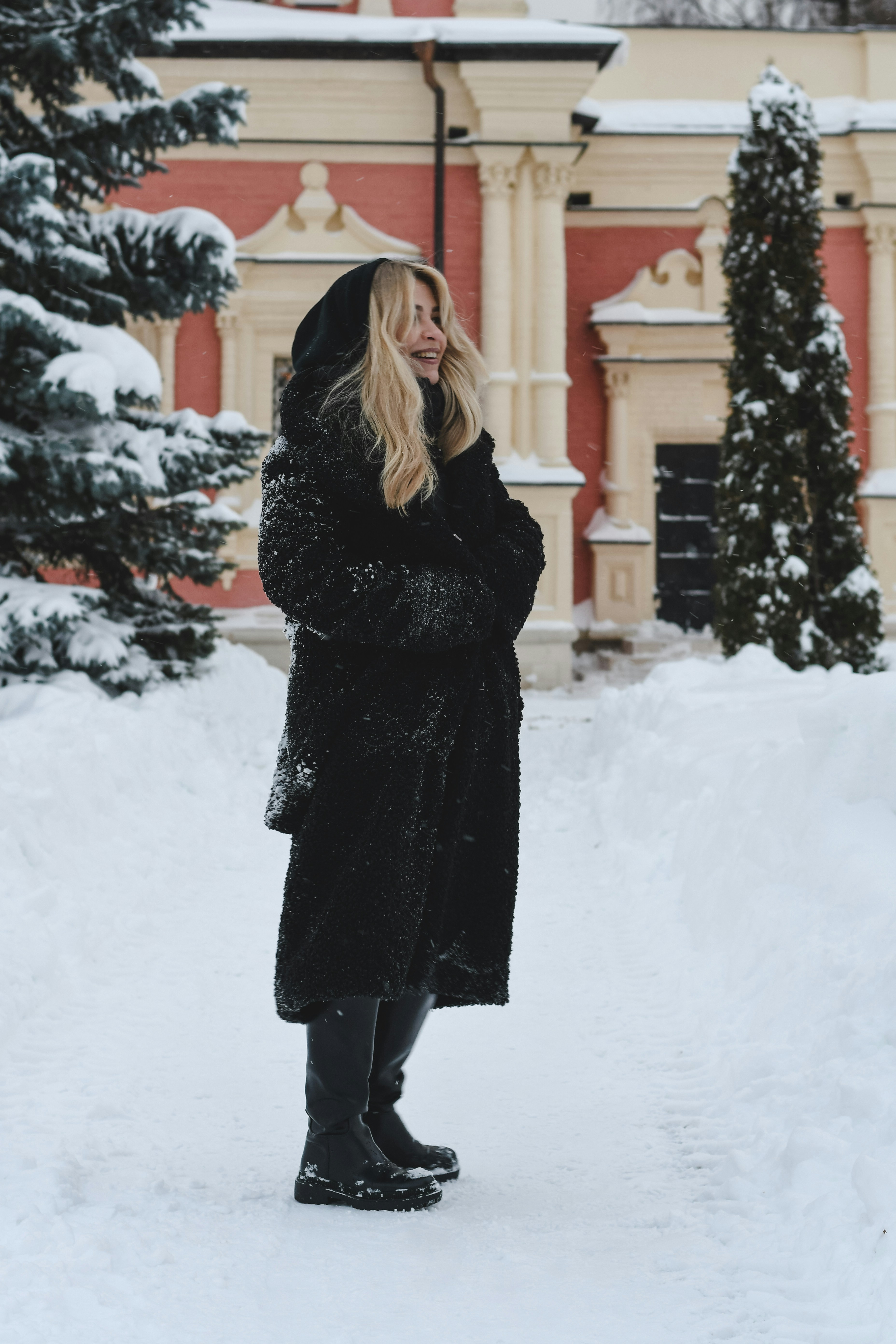 A woman in a black fur coat in the snow