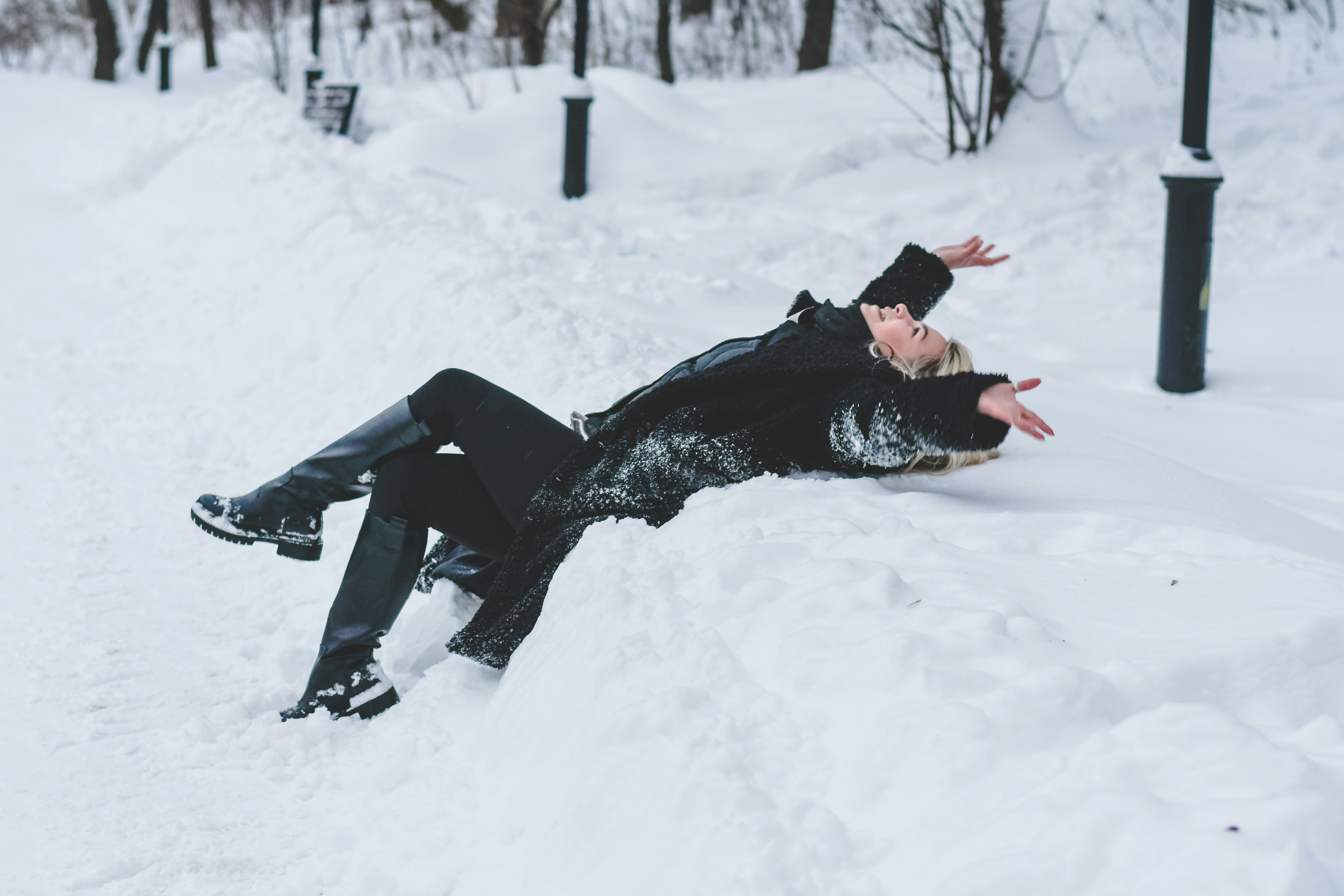 A couple dances playfully in the snow