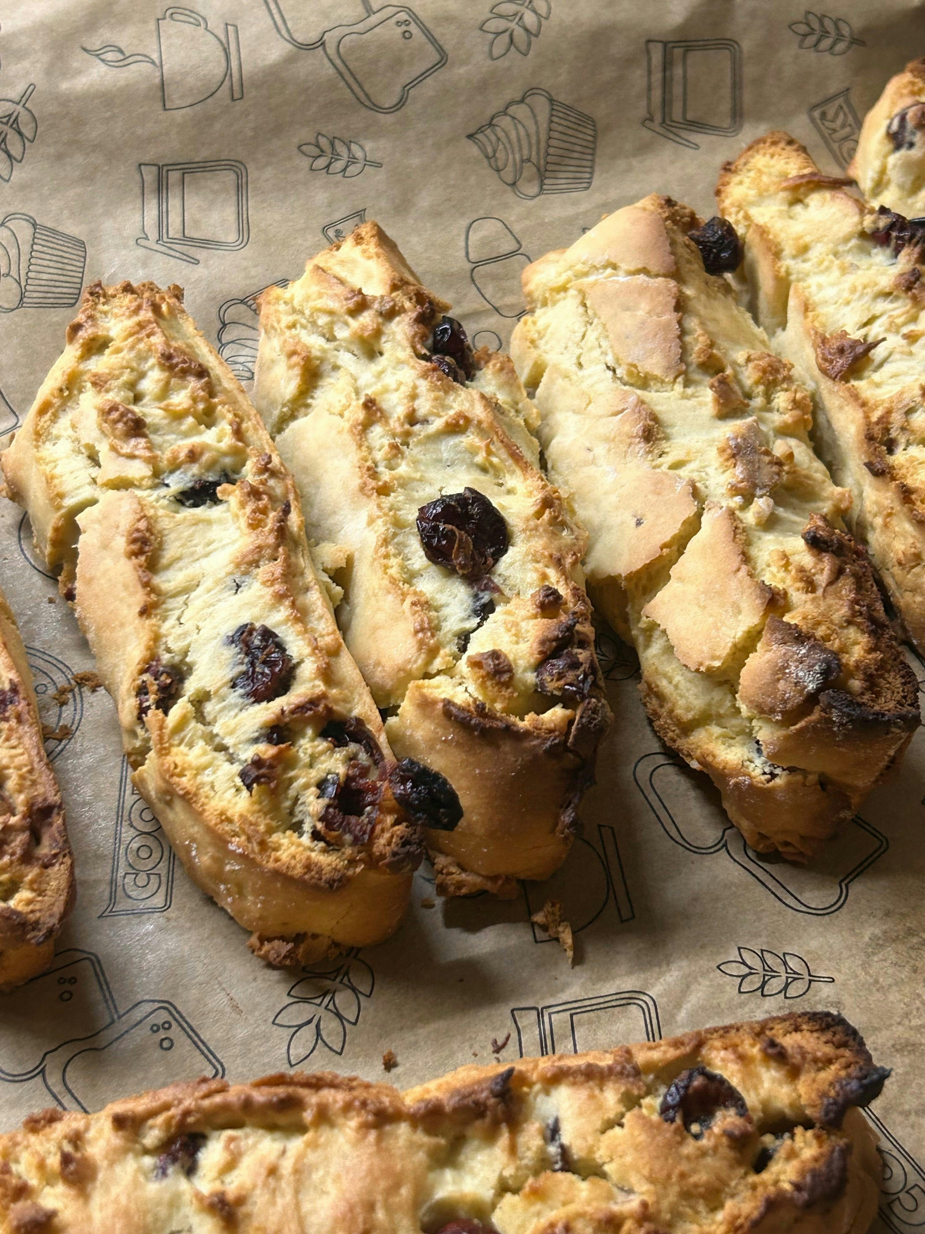 Golden brown biscotti with raisins on parchment paper