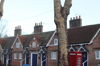 Brick cottages with blue doors and red phone booth.