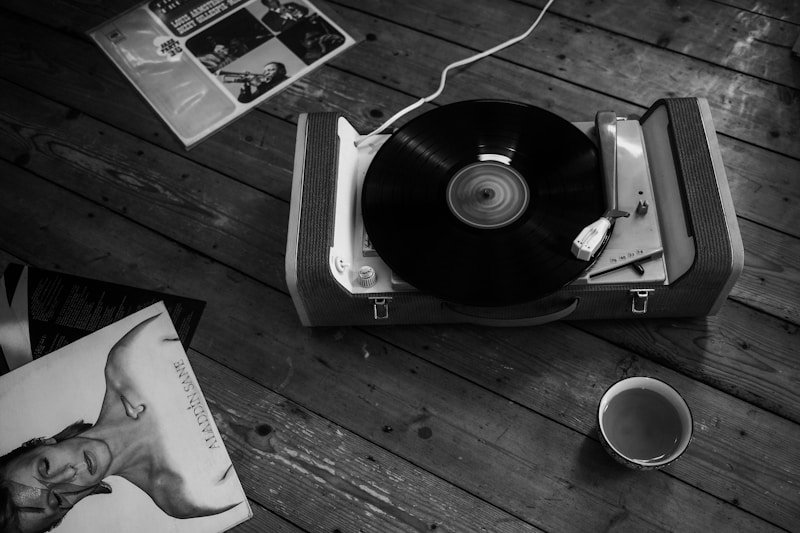 Vintage record player with vinyl records and a warm cup of coffee — the soul of Book 615's 70s music experience