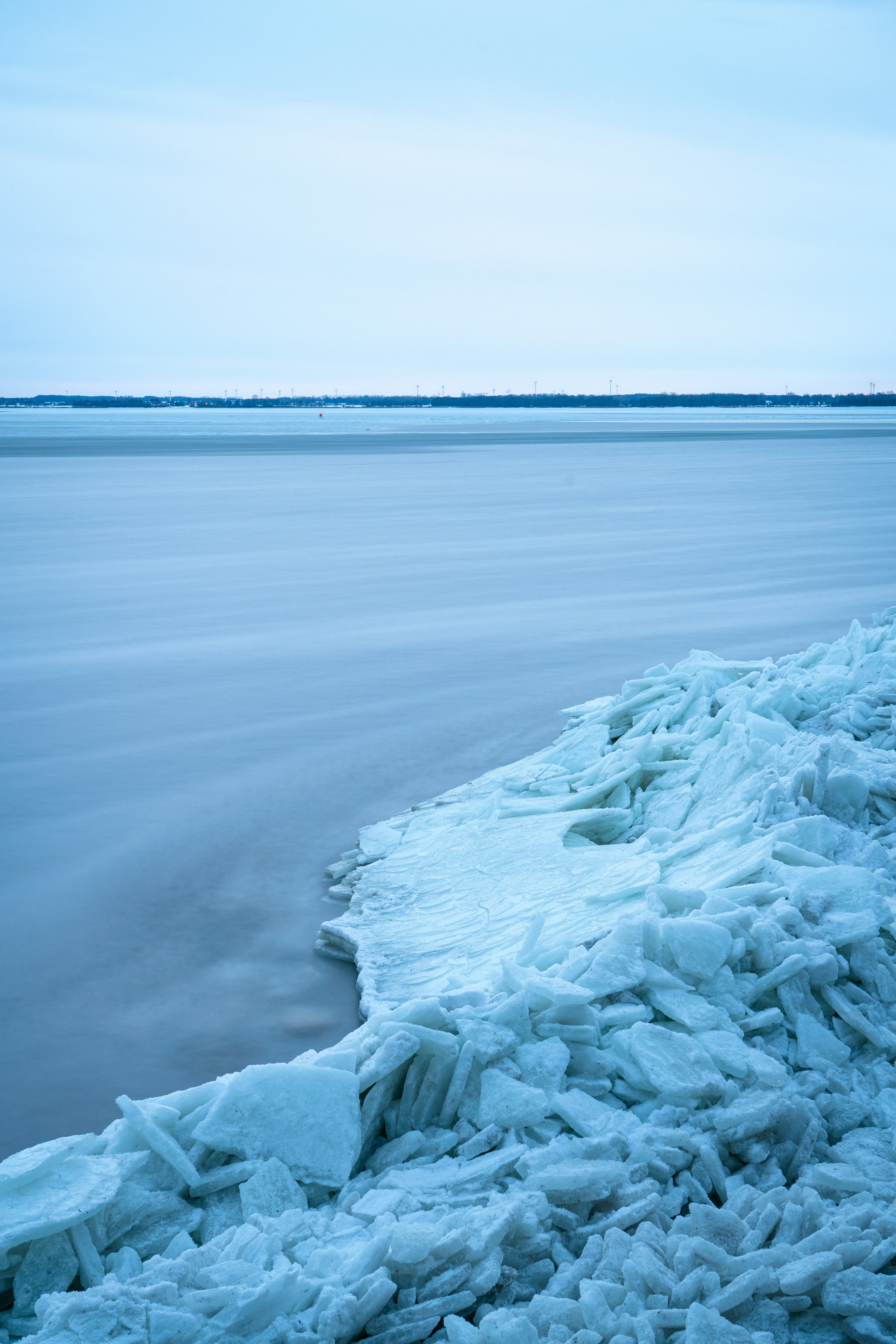 Ice chunks pile up on a frozen lake shore
