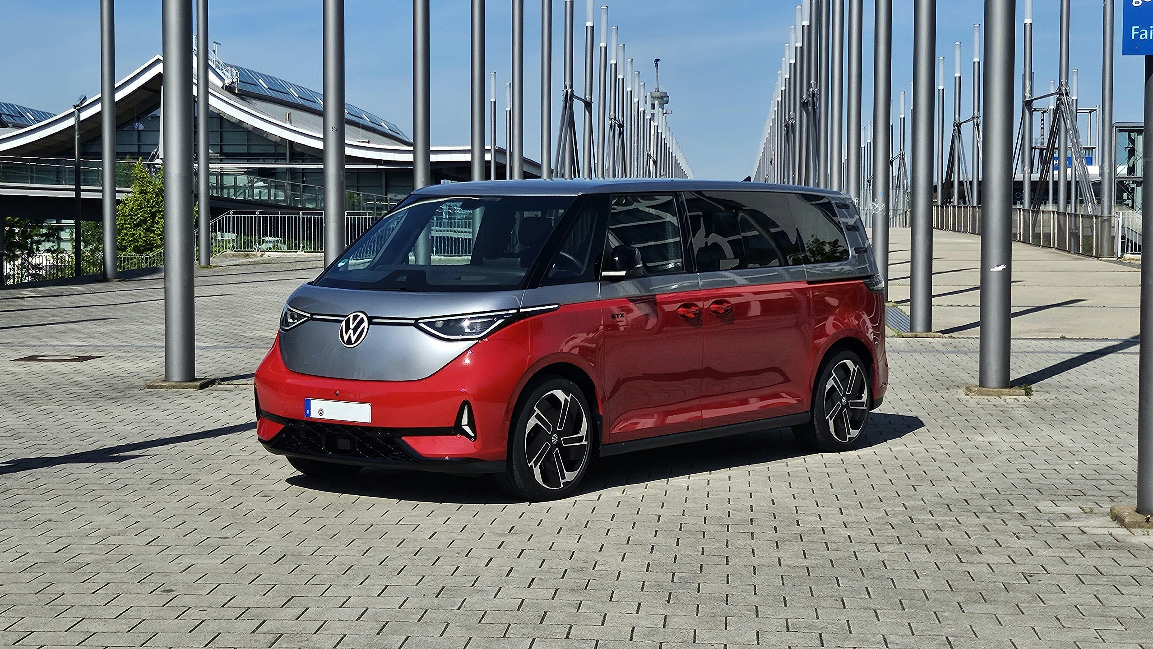 Red and silver van parked outdoors near stadium structure