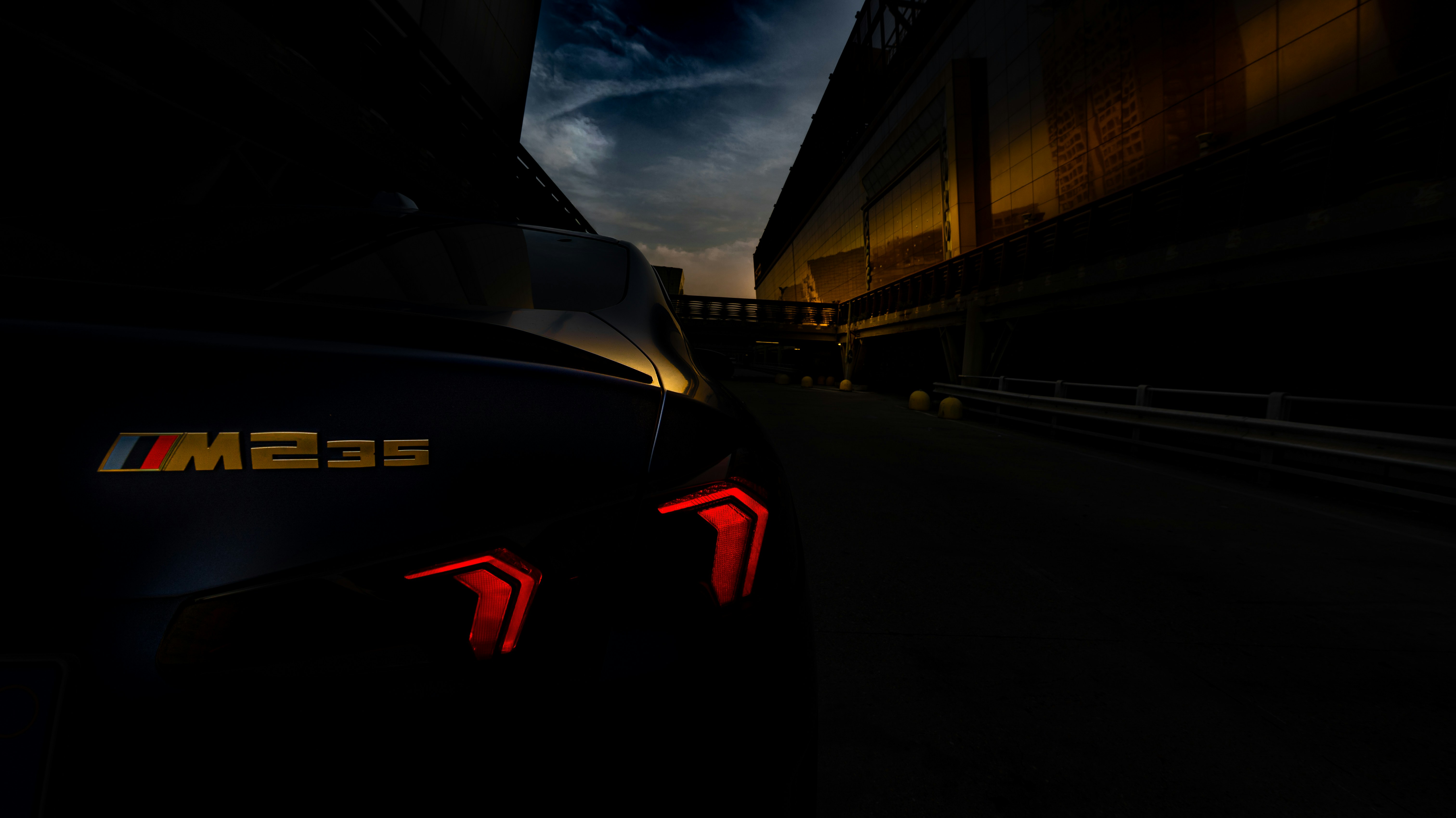 Dark moody shot of a car's taillights at night.
