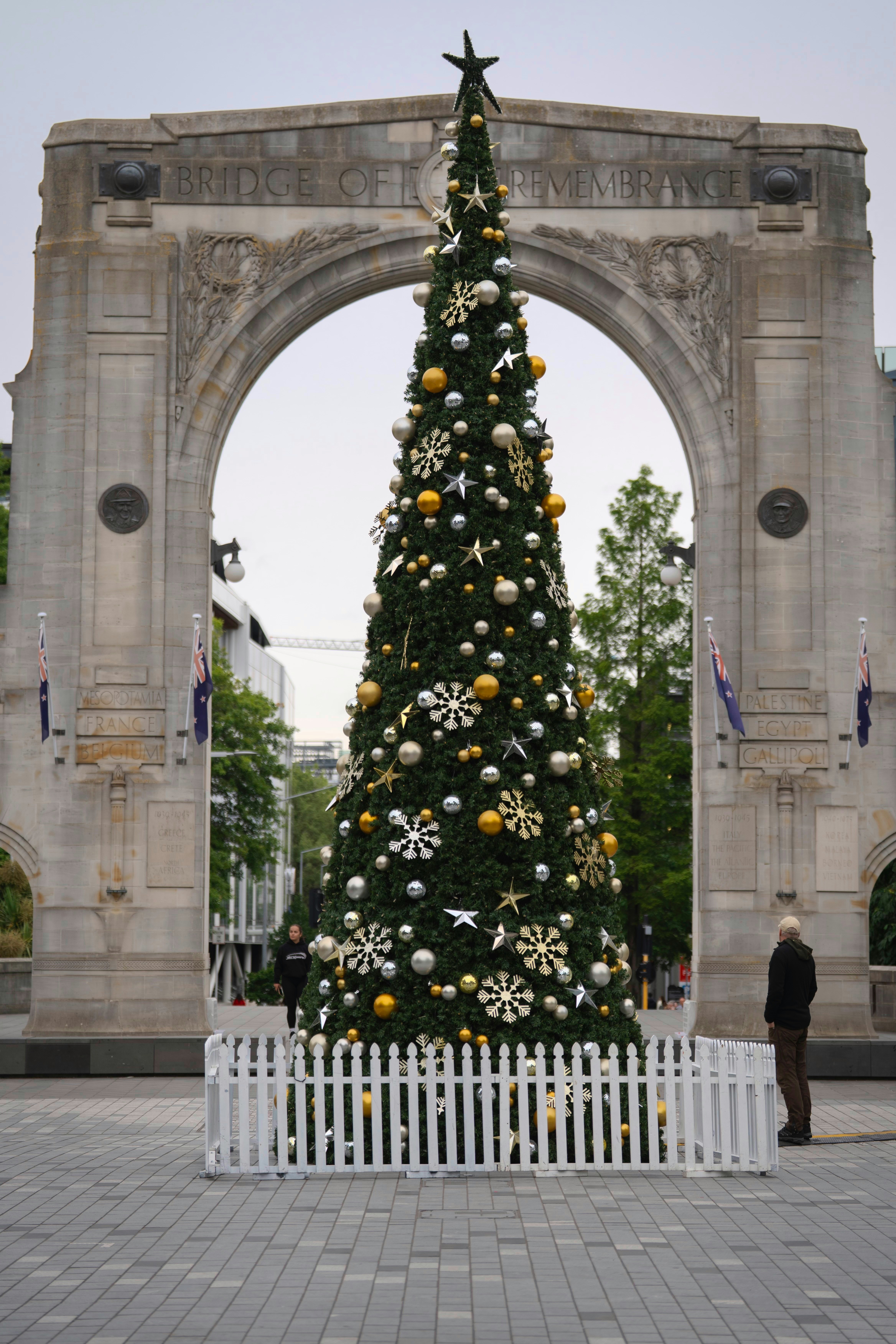 Decorated christmas tree under a stone archway