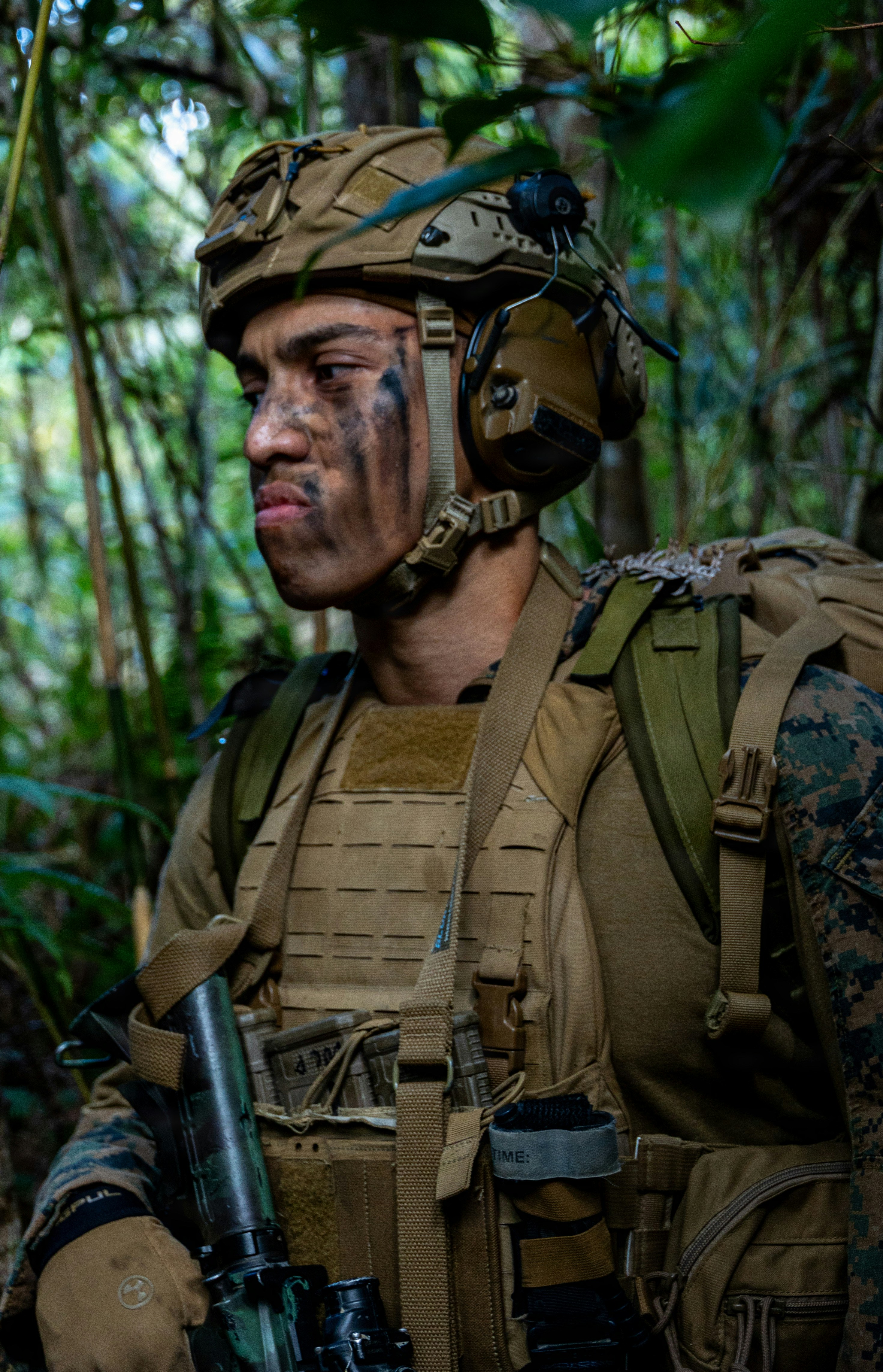 Marine in jungle with face paint and gear