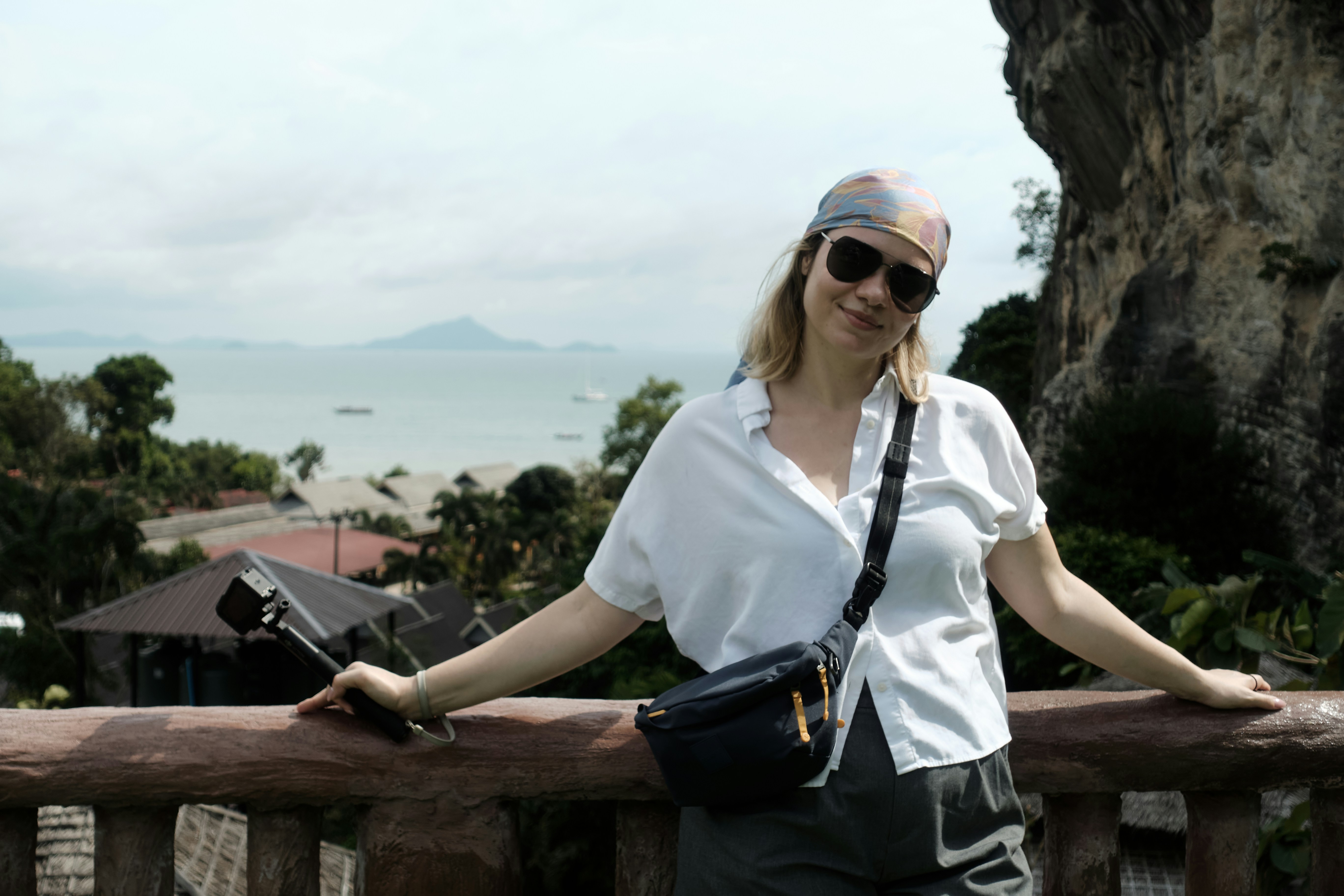 Woman with sunglasses and bandana at scenic overlook