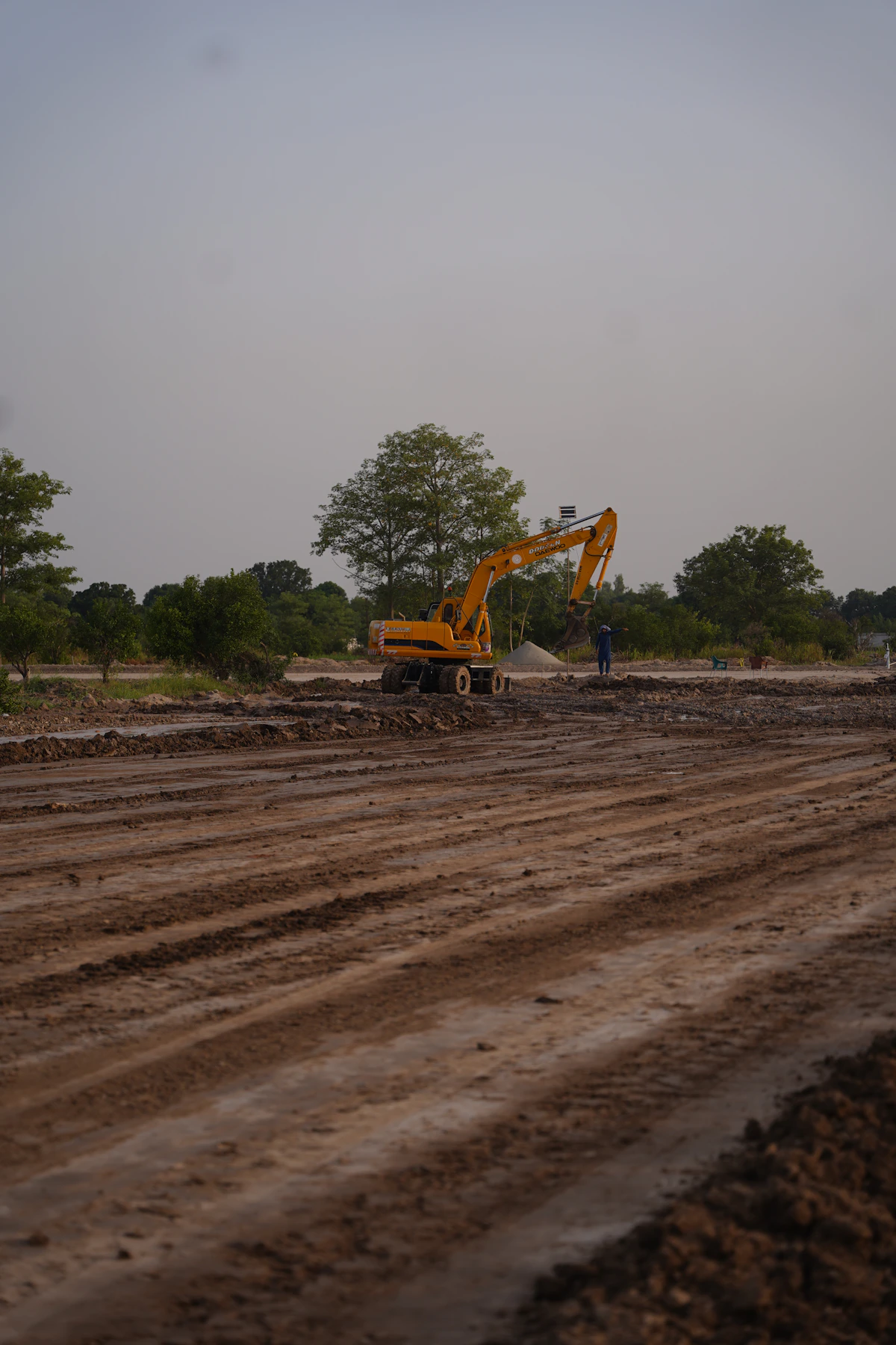 Crawler excavator operating amid dirt and rubble on a construction site
