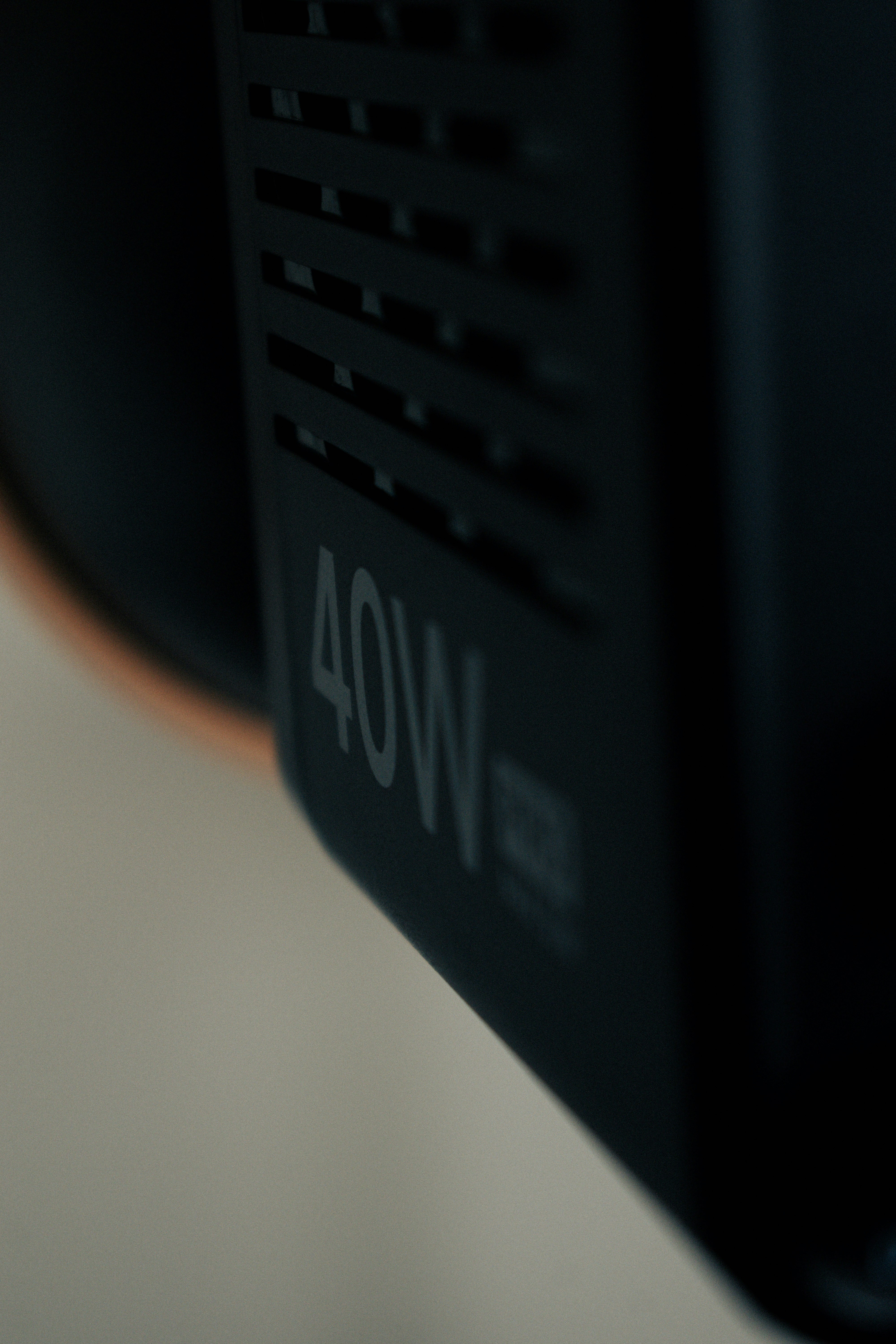 Close-up of a black device with "40w" marking.