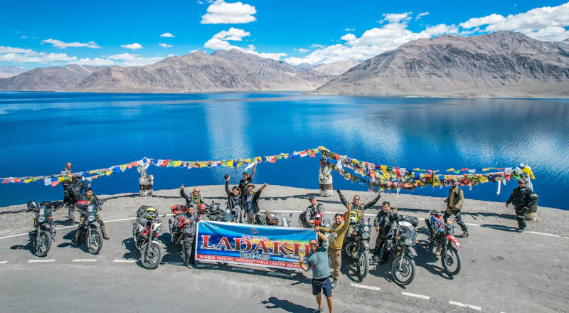 Bikers gathered by a mountain lake