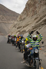 Group of motorcyclists riding on a mountain road