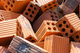 Pile of orange bricks with holes