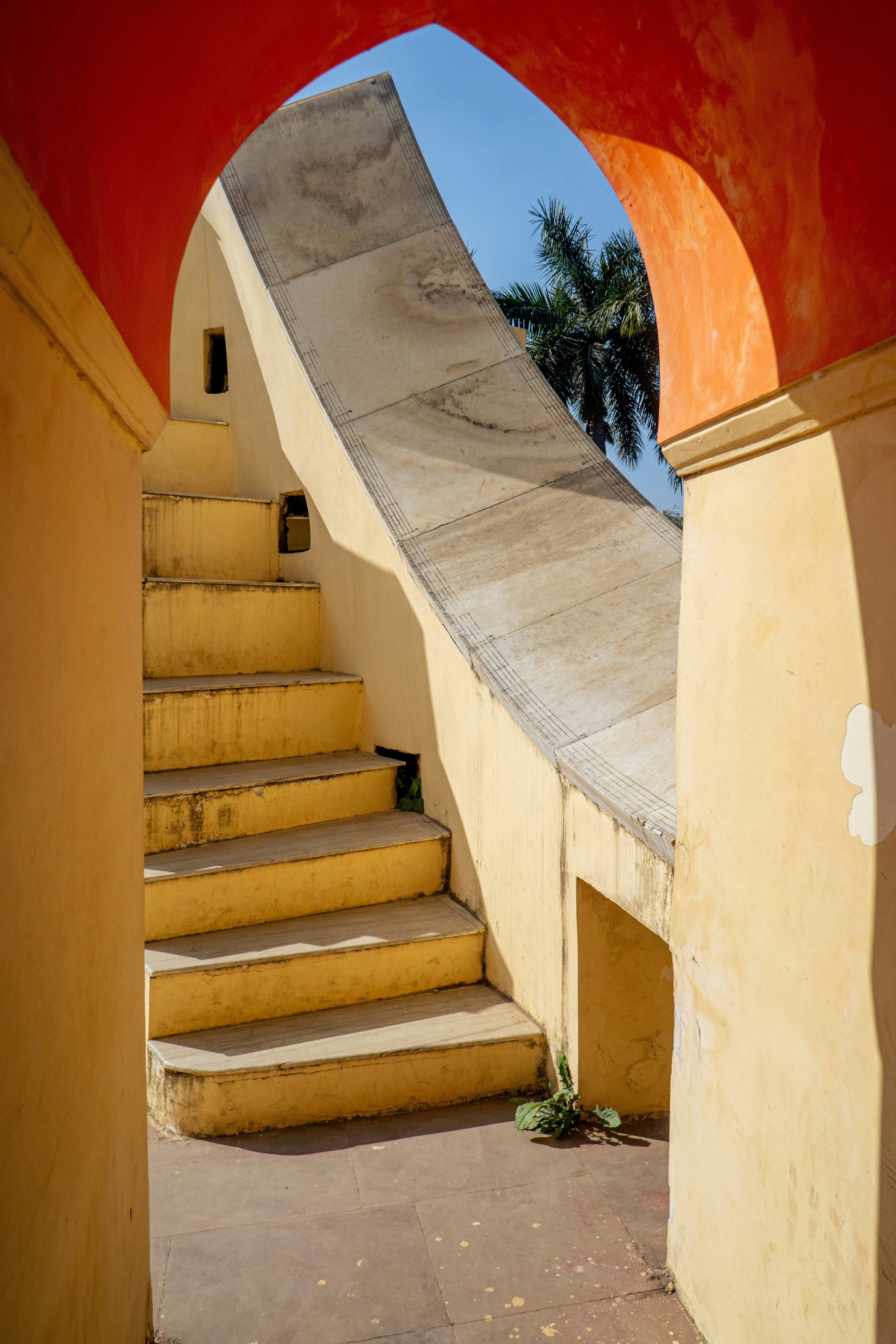Yellow stone steps leading to a large sundial