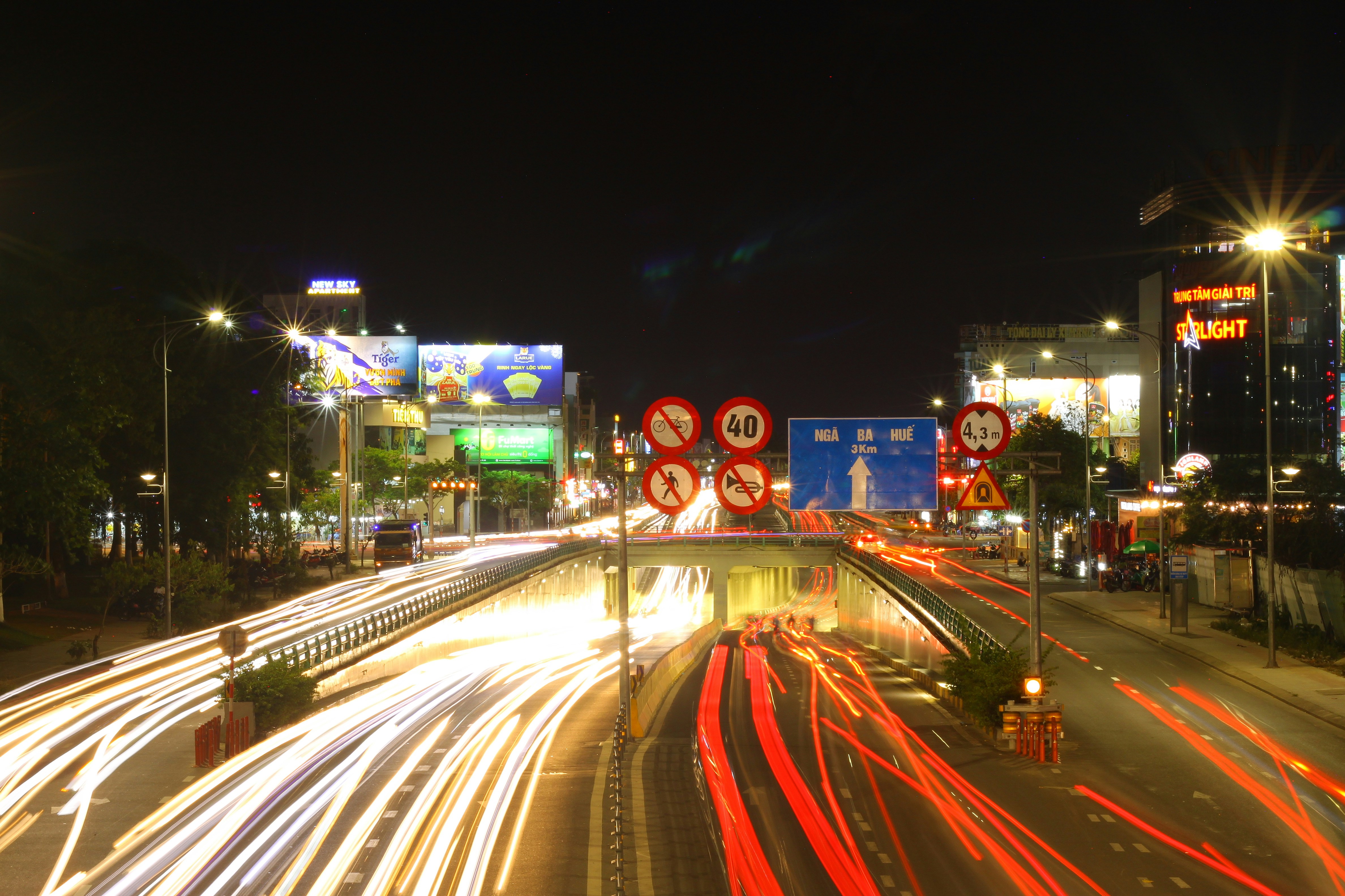 City street at night with light trails from cars