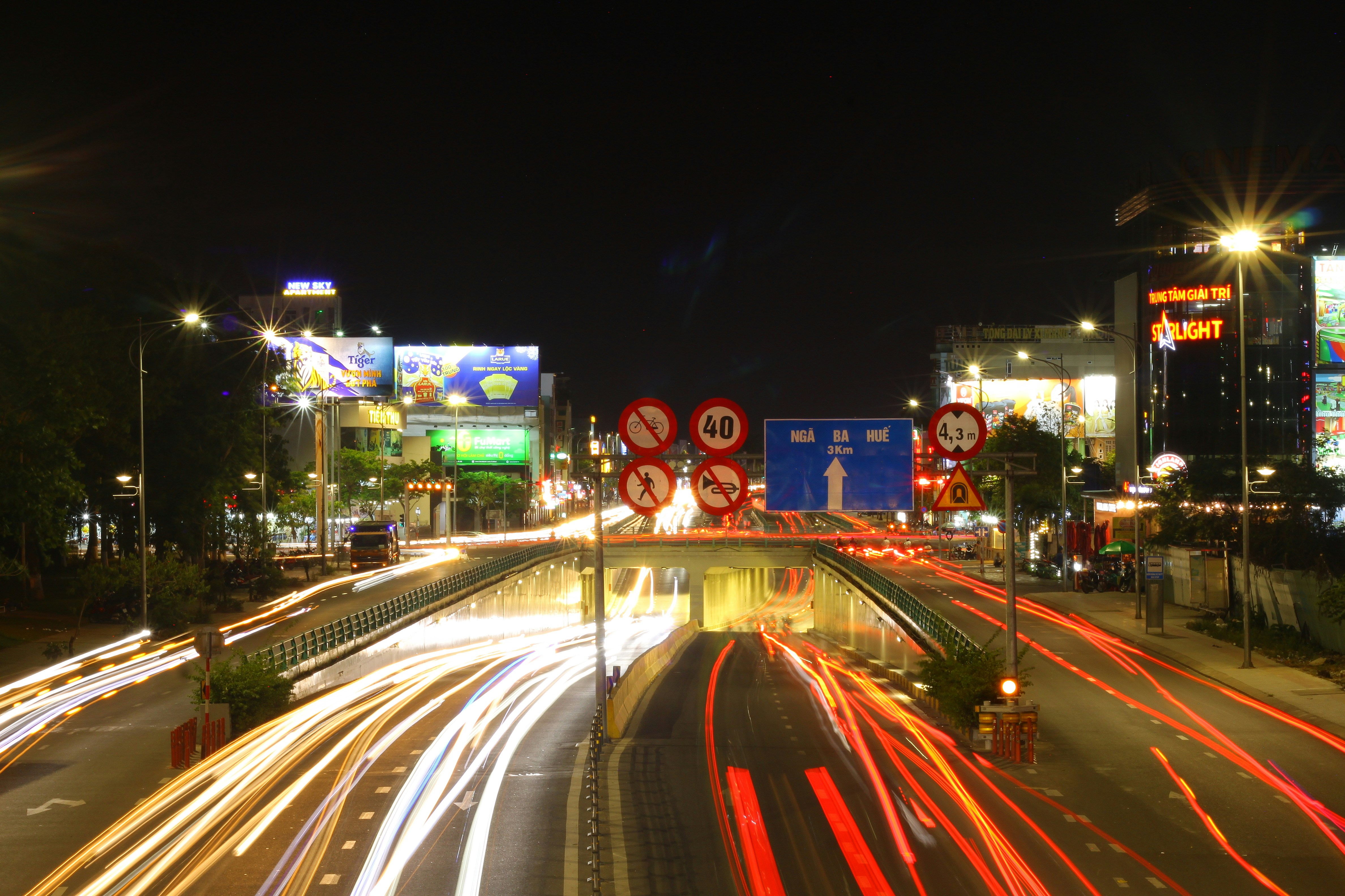 City street at night with light trails from traffic