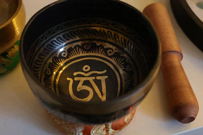 A tibetan singing bowl with ornate carvings and sacred symbols.