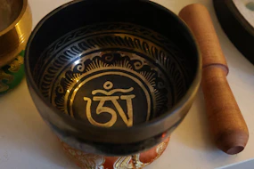 A tibetan singing bowl with ornate carvings and sacred symbols.