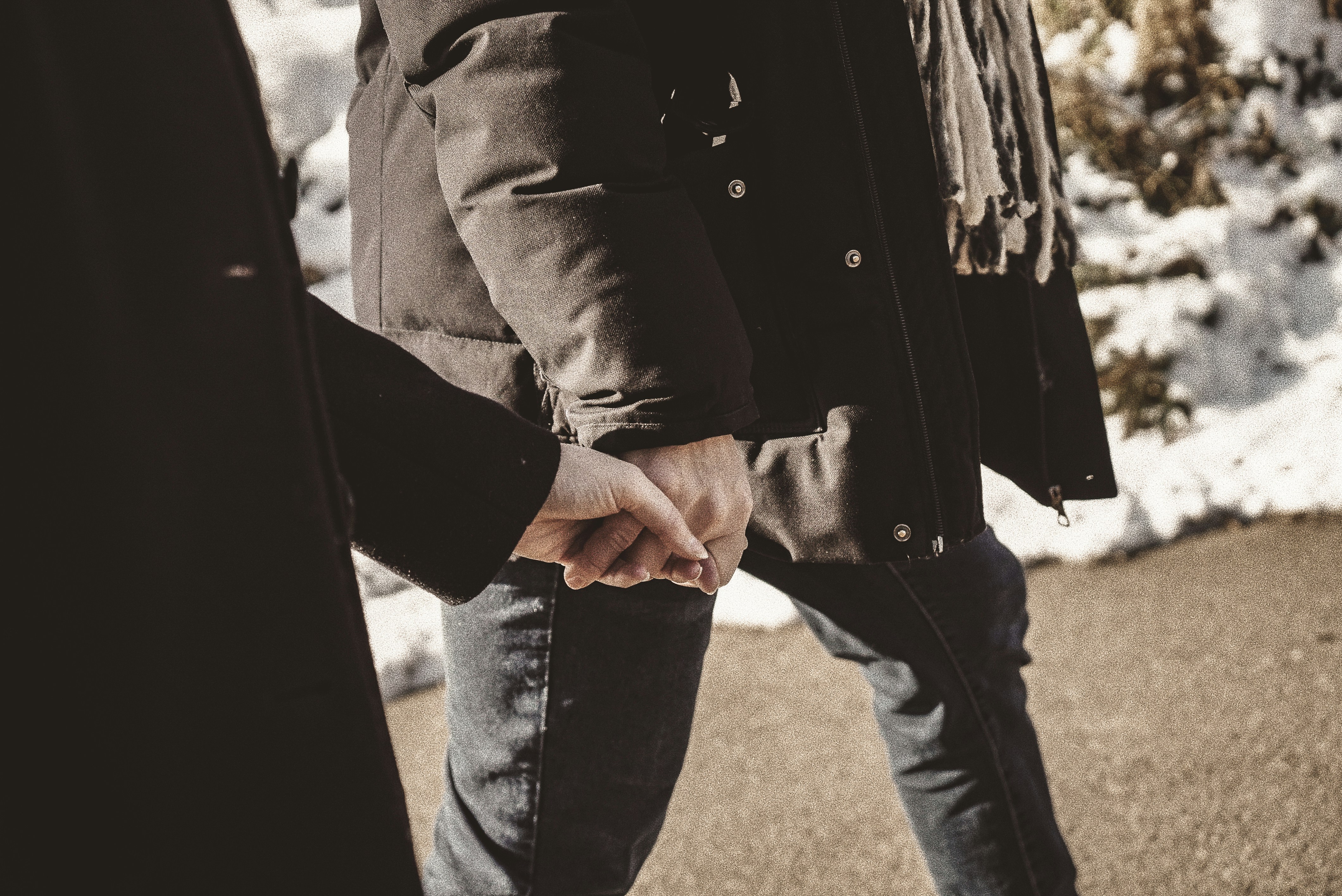 Two people holding hands in winter
