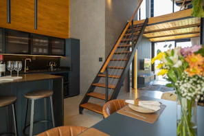 Modern kitchen with loft and staircase