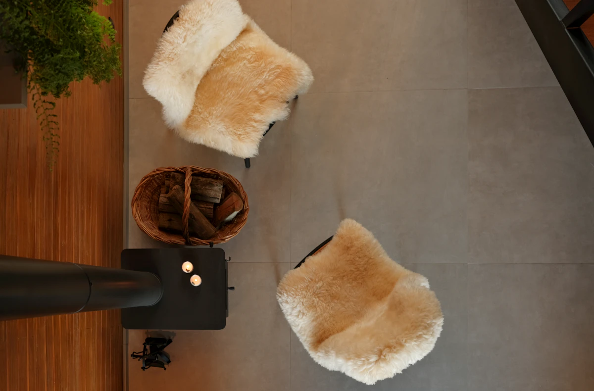 Two reading chairs and a wooden basket of throws
