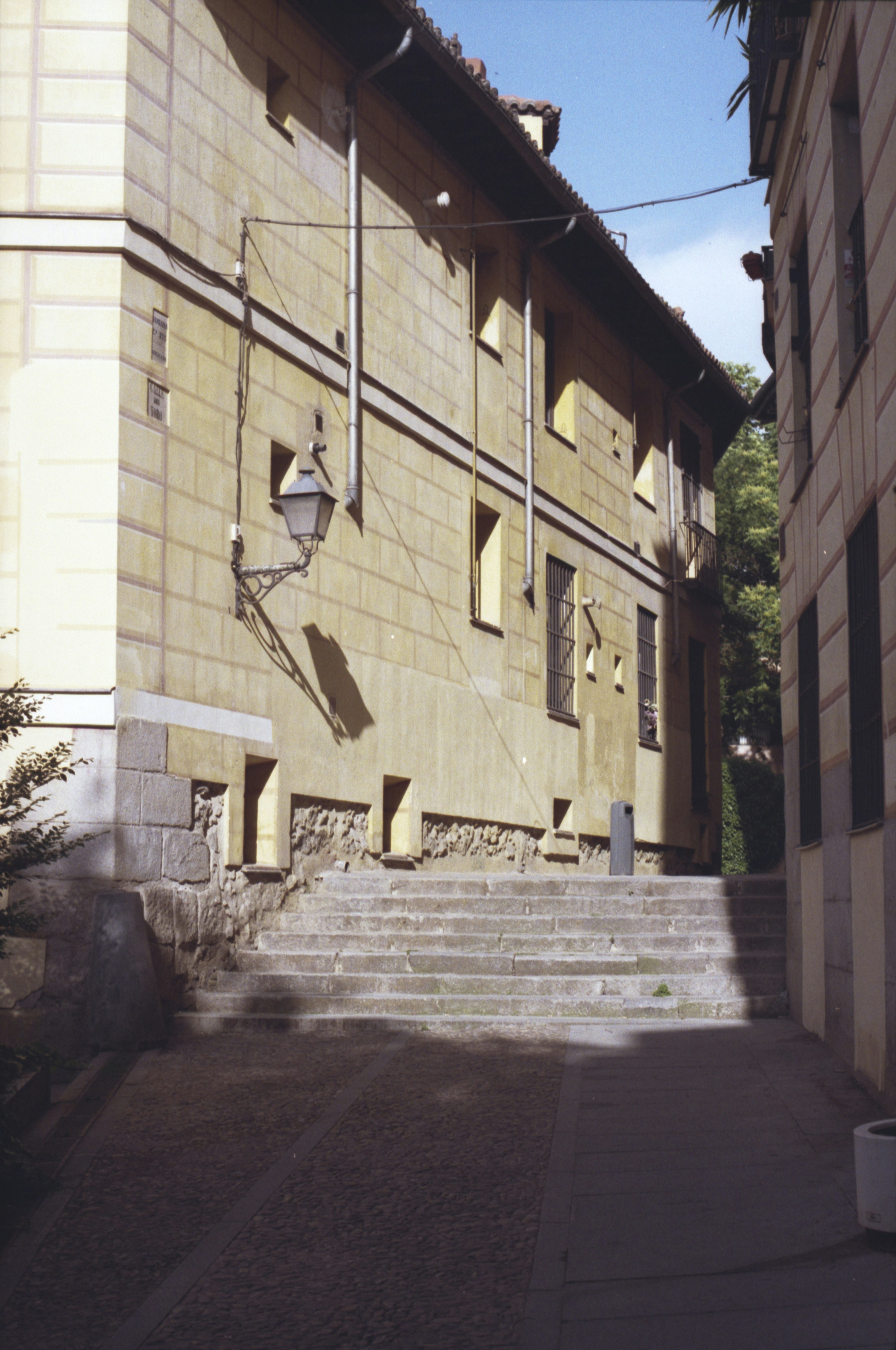 Stone steps lead up a narrow street between buildings.