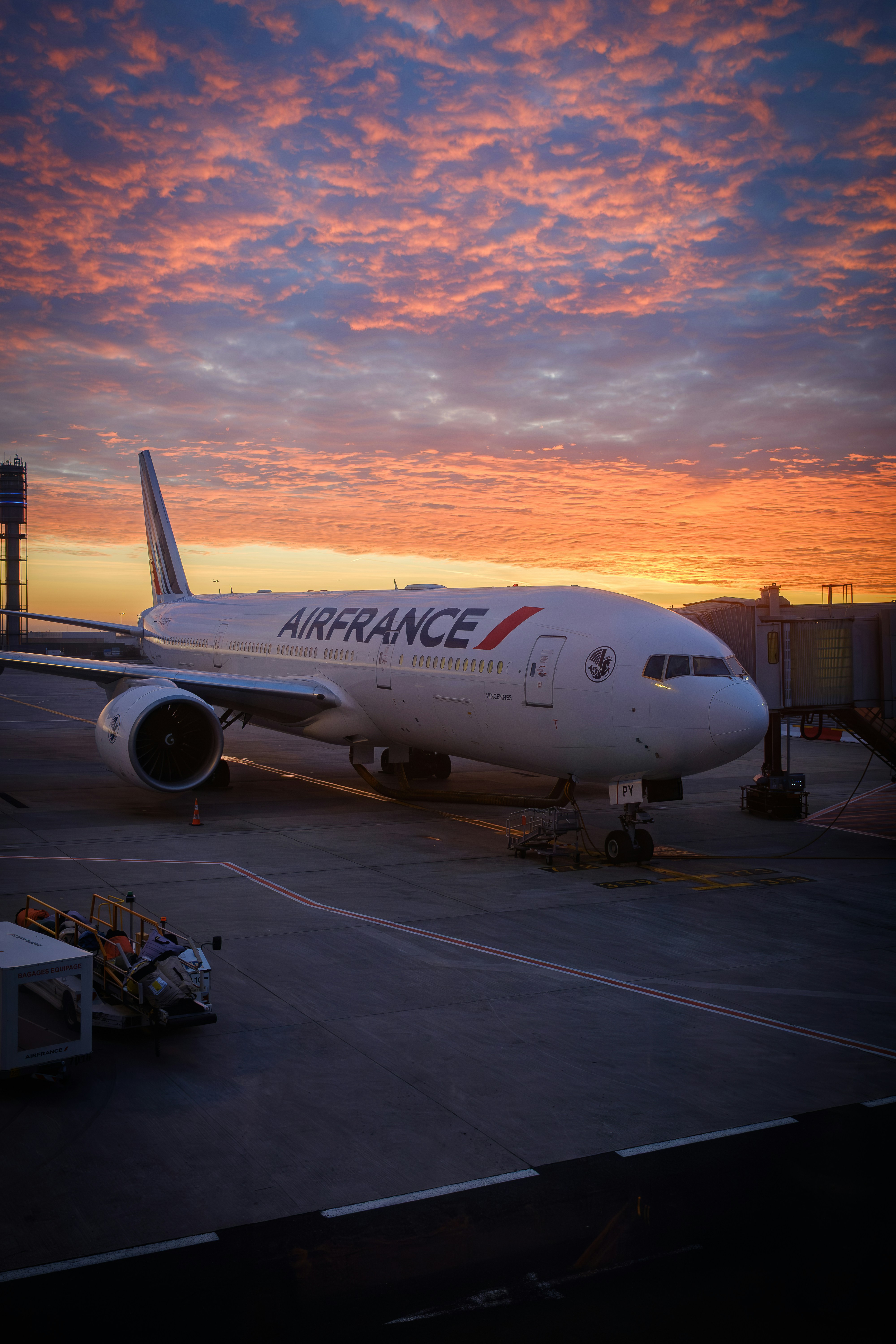 Air france airplane parked at gate during sunset