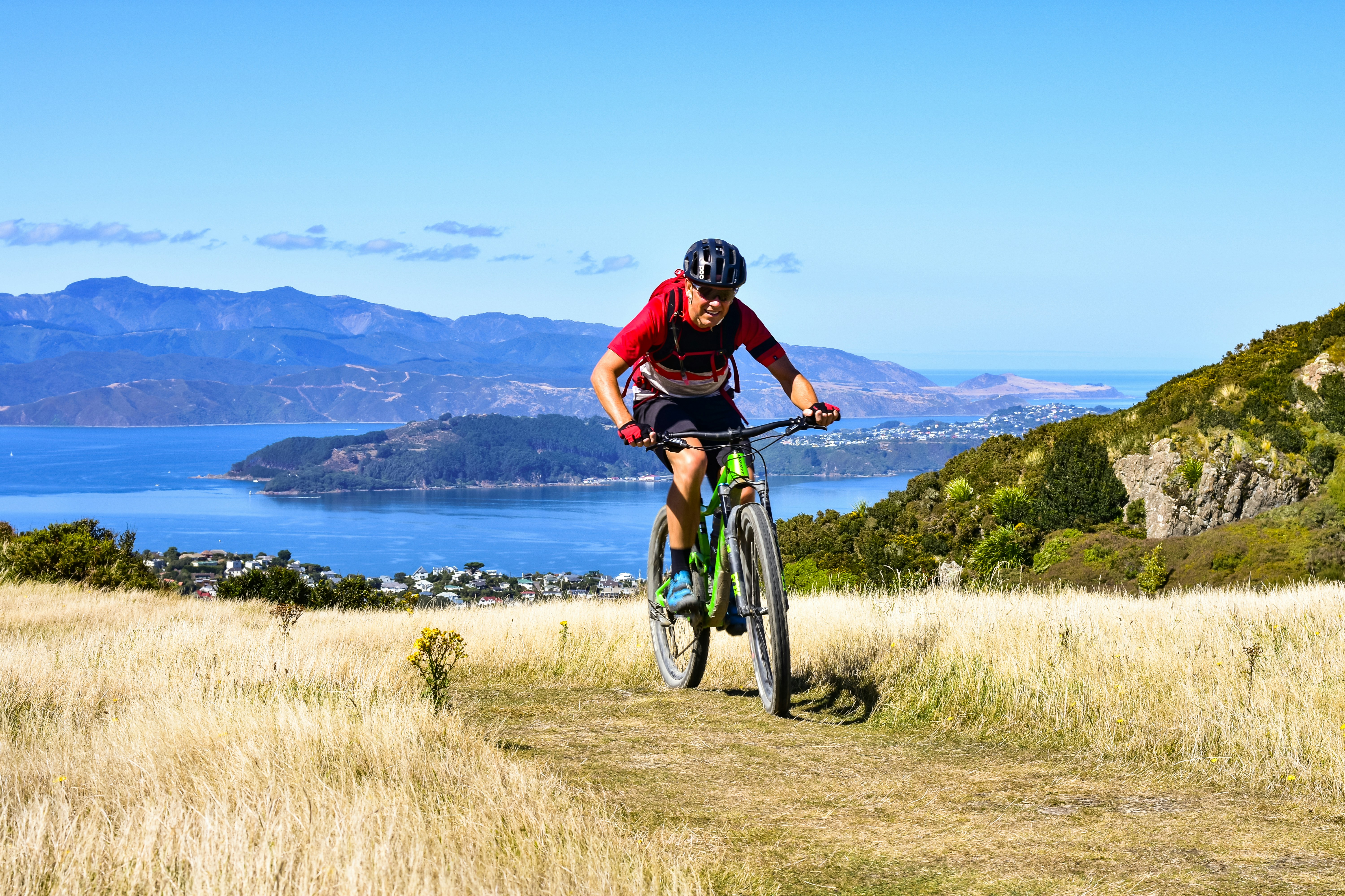 Cyclist riding a green trail on the hills, an environmentally friendly outdoor activity