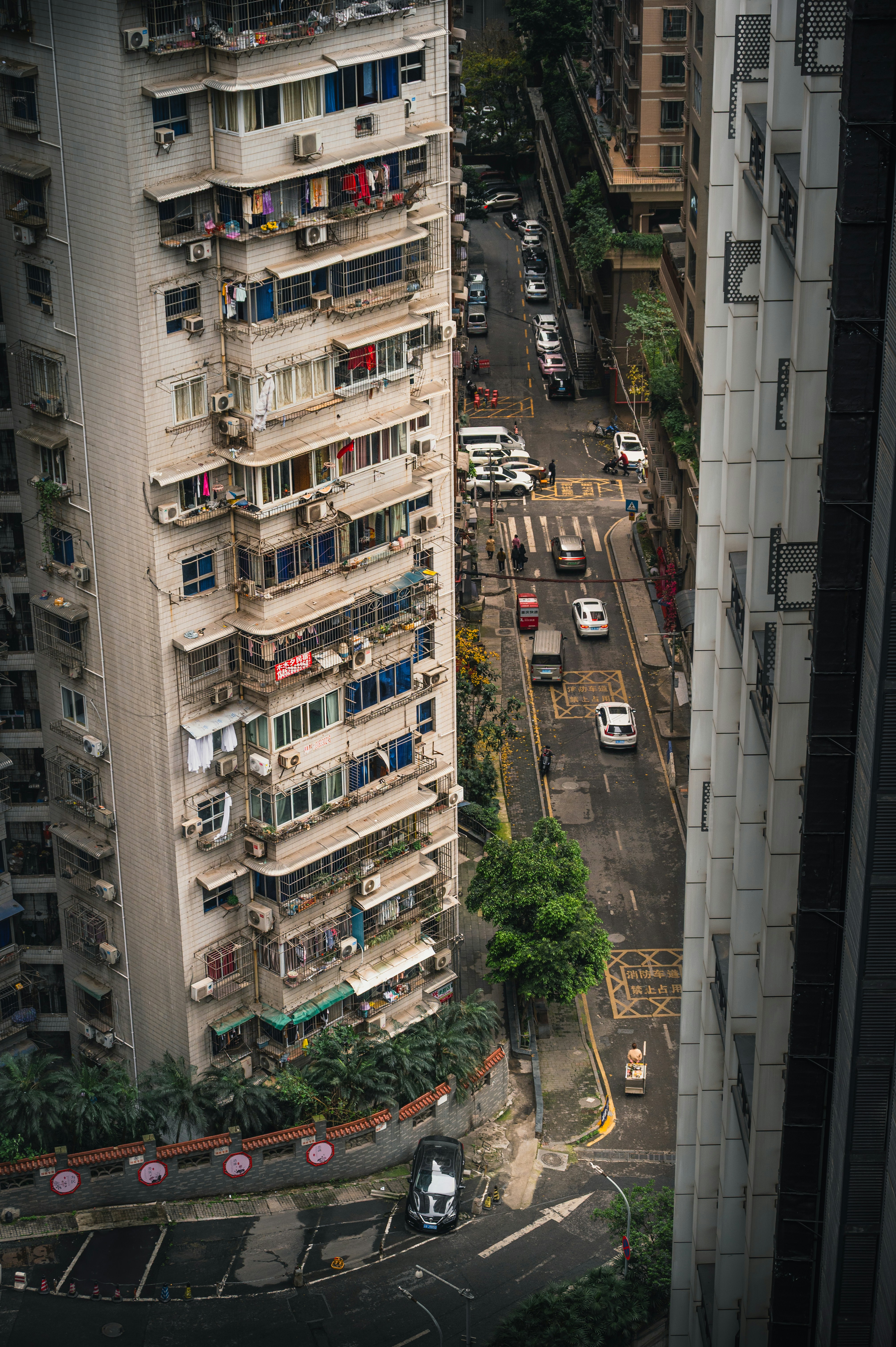 Tall apartment buildings line a busy city street.
