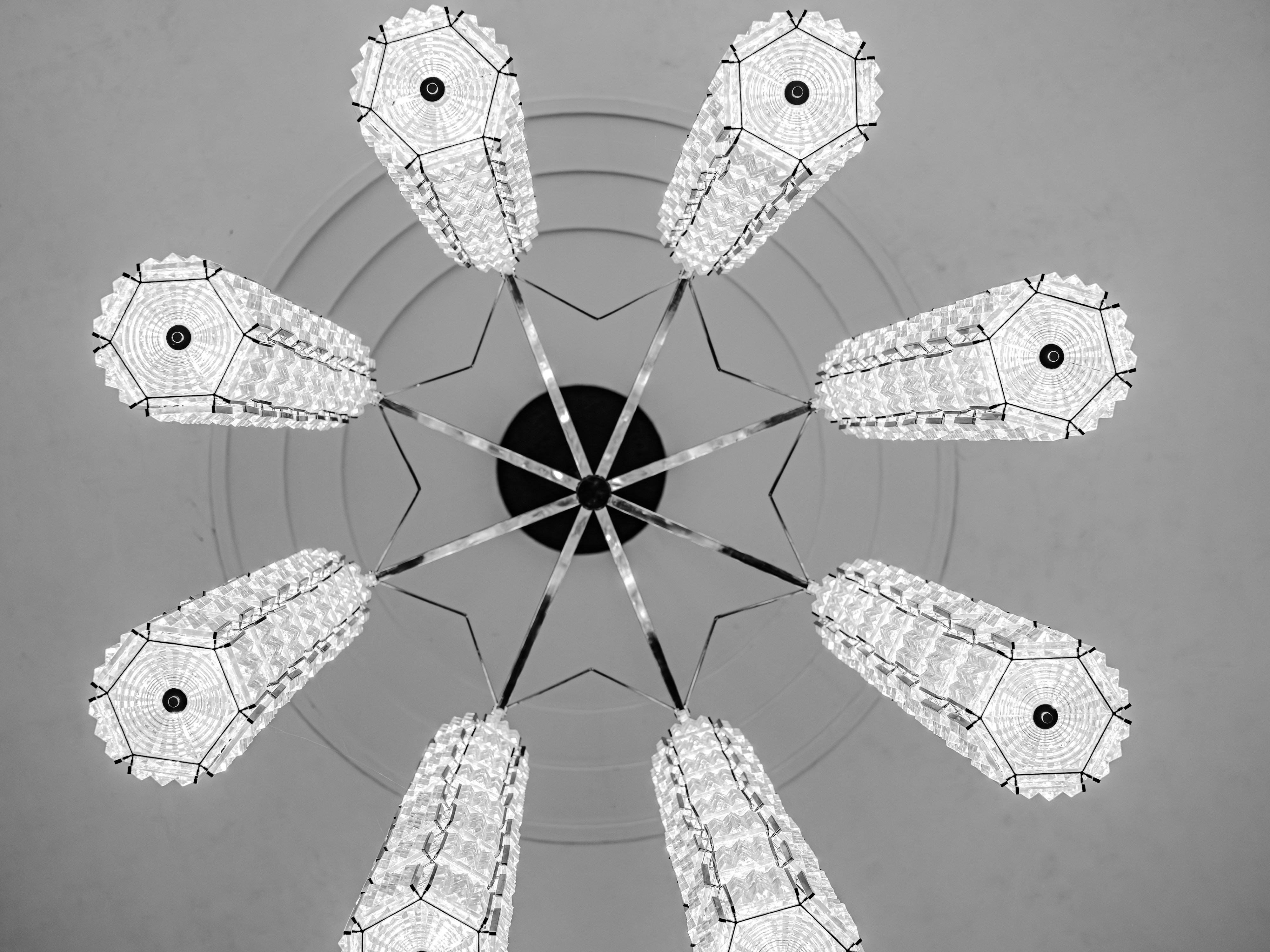 Eight hexagonal chandeliers arranged in a circle